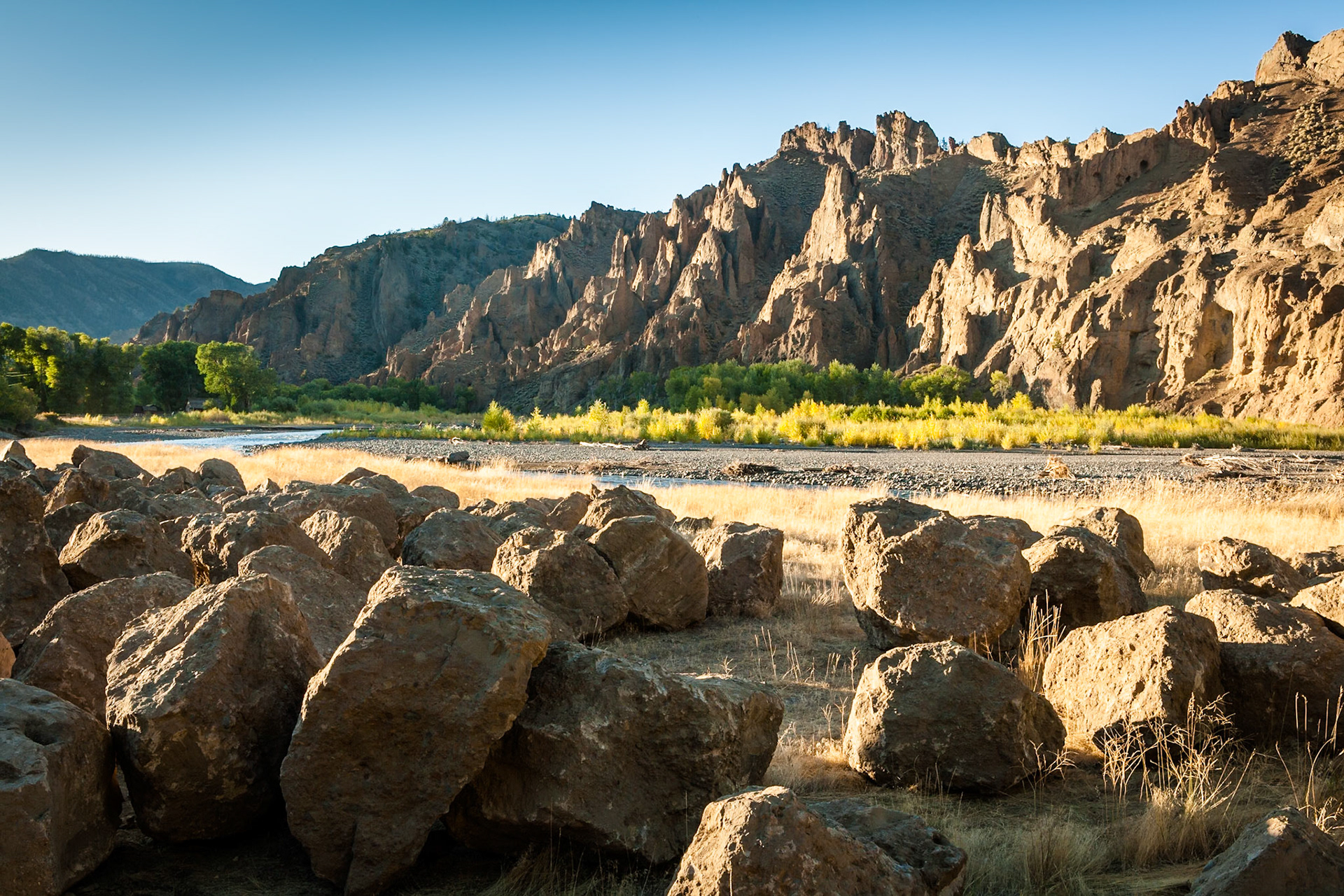 Big boulders and rocks at either side of the Shoshone River at Wapiti Valley, Wyoming, USA