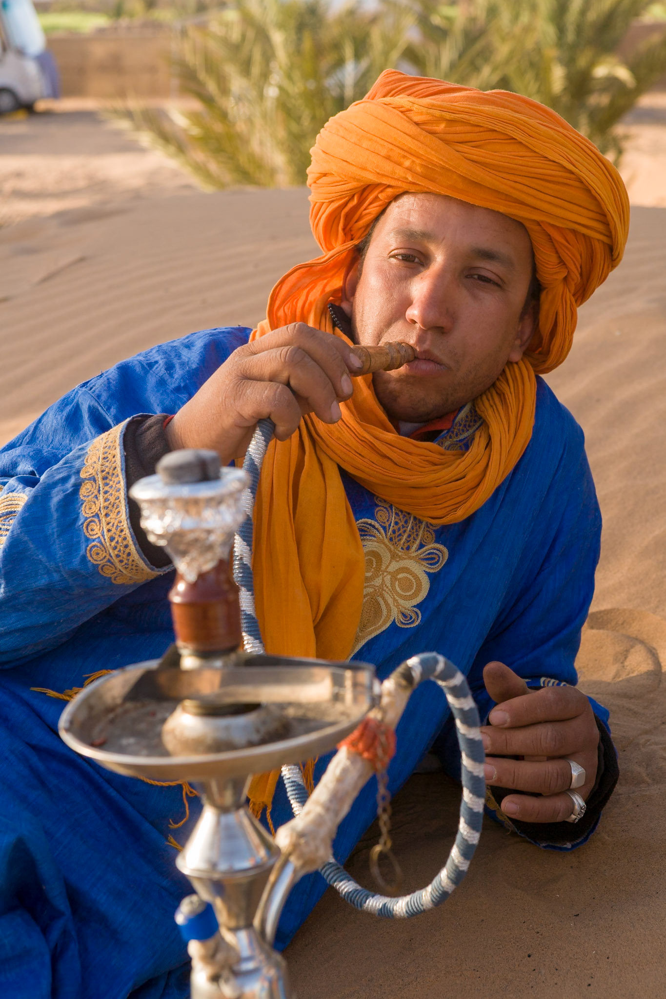 Berber man with water pipe near merzouga