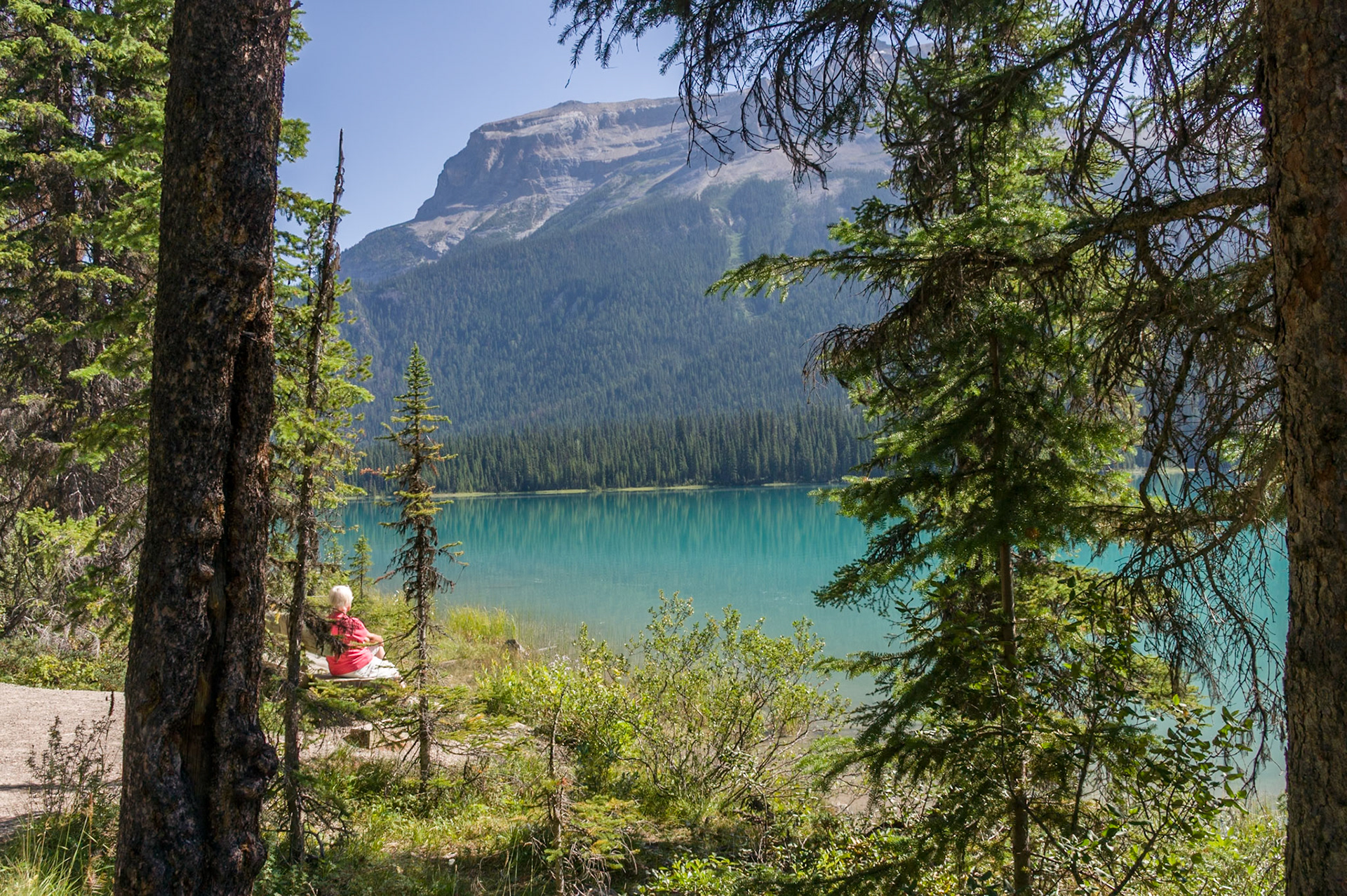 woman resting during hike around Emerald Lake, Yoho National Park, BC, CA