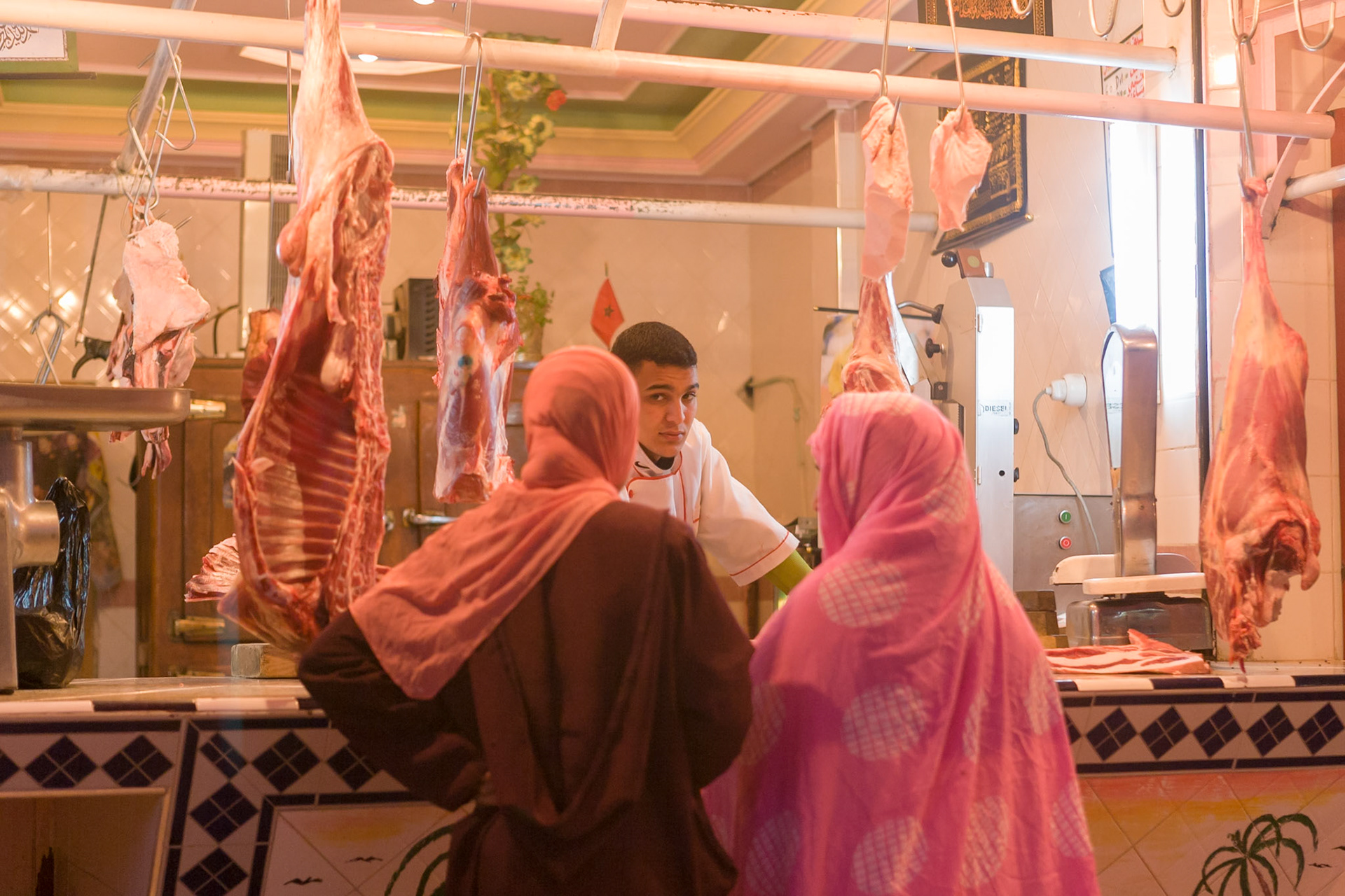 Women talking with butcher at evening at Guelmim