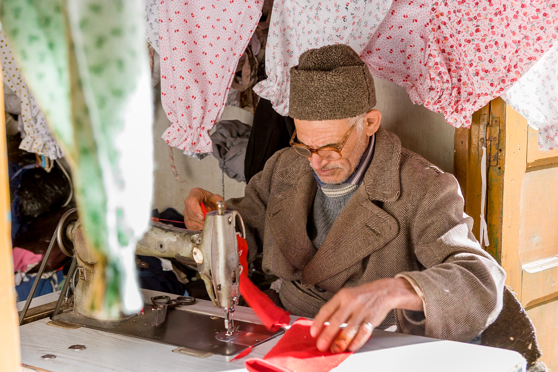 Man working at a sewing machine at souk at Sale