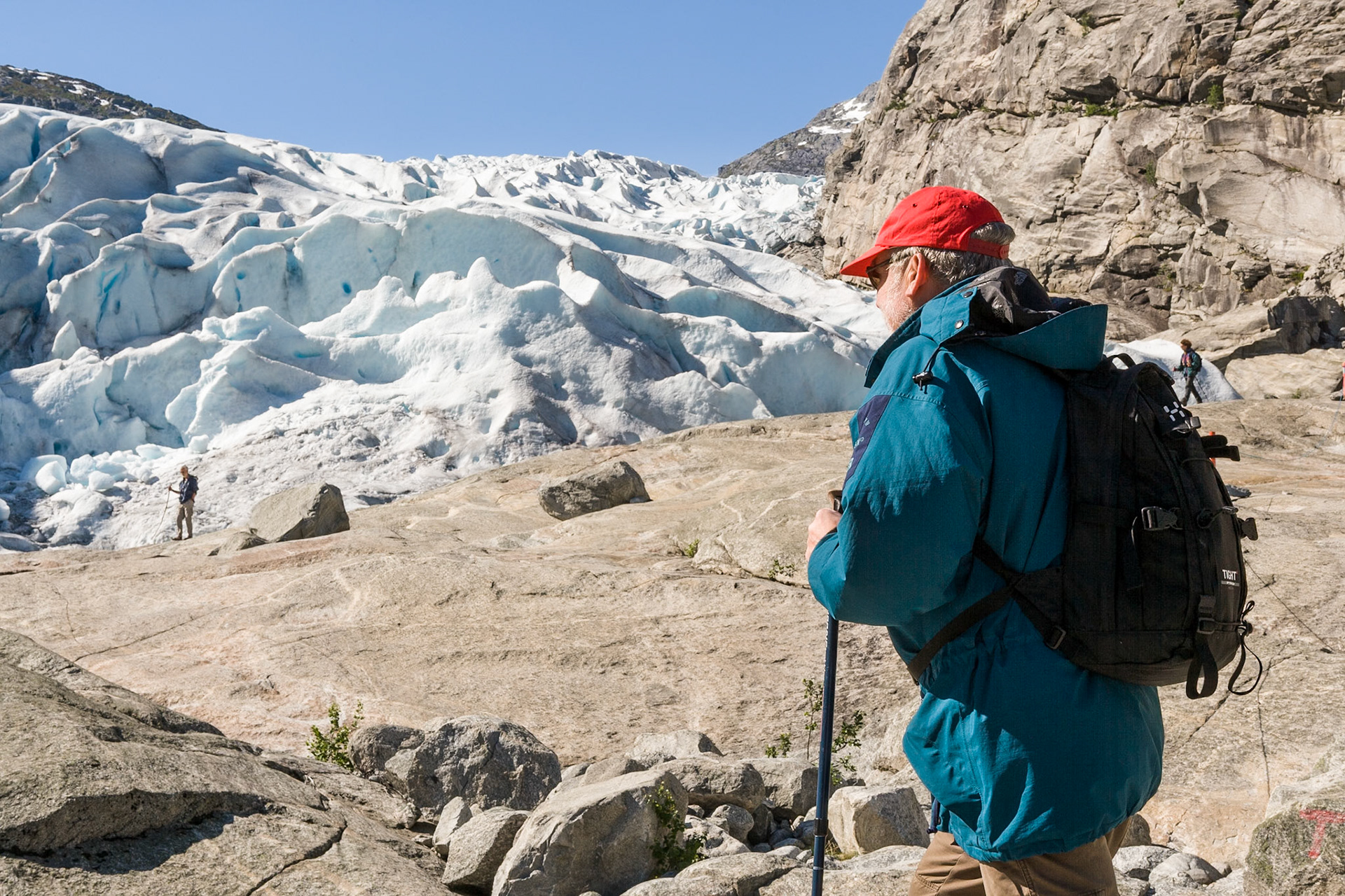 Hiker looks at Nigardsbreen Glacier at Jostedalbreen Nasjonal (national) Park