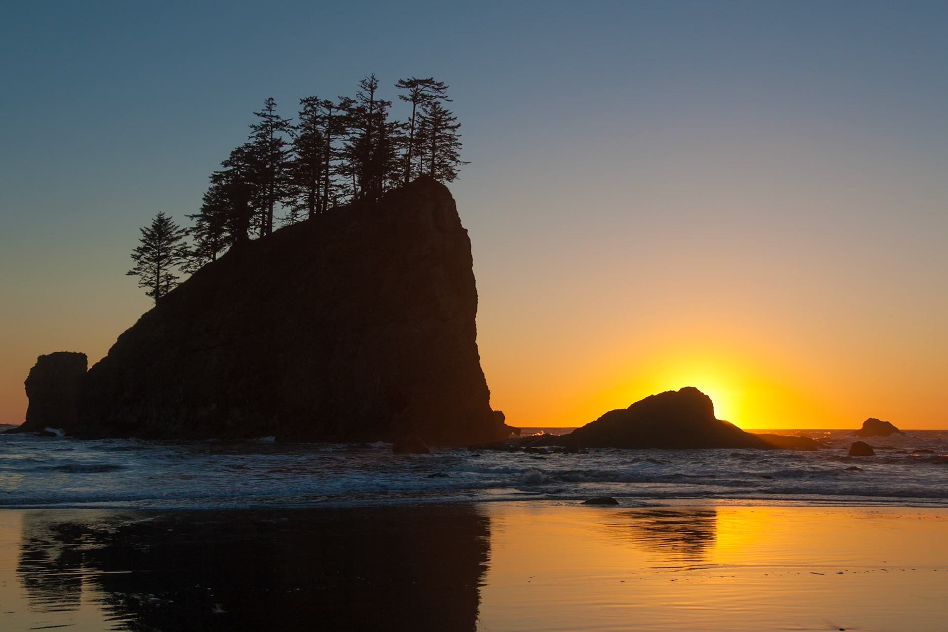 Silhouet rock against a sunset sky at Second Beach near La Push in Olympic National Park, WA, USA