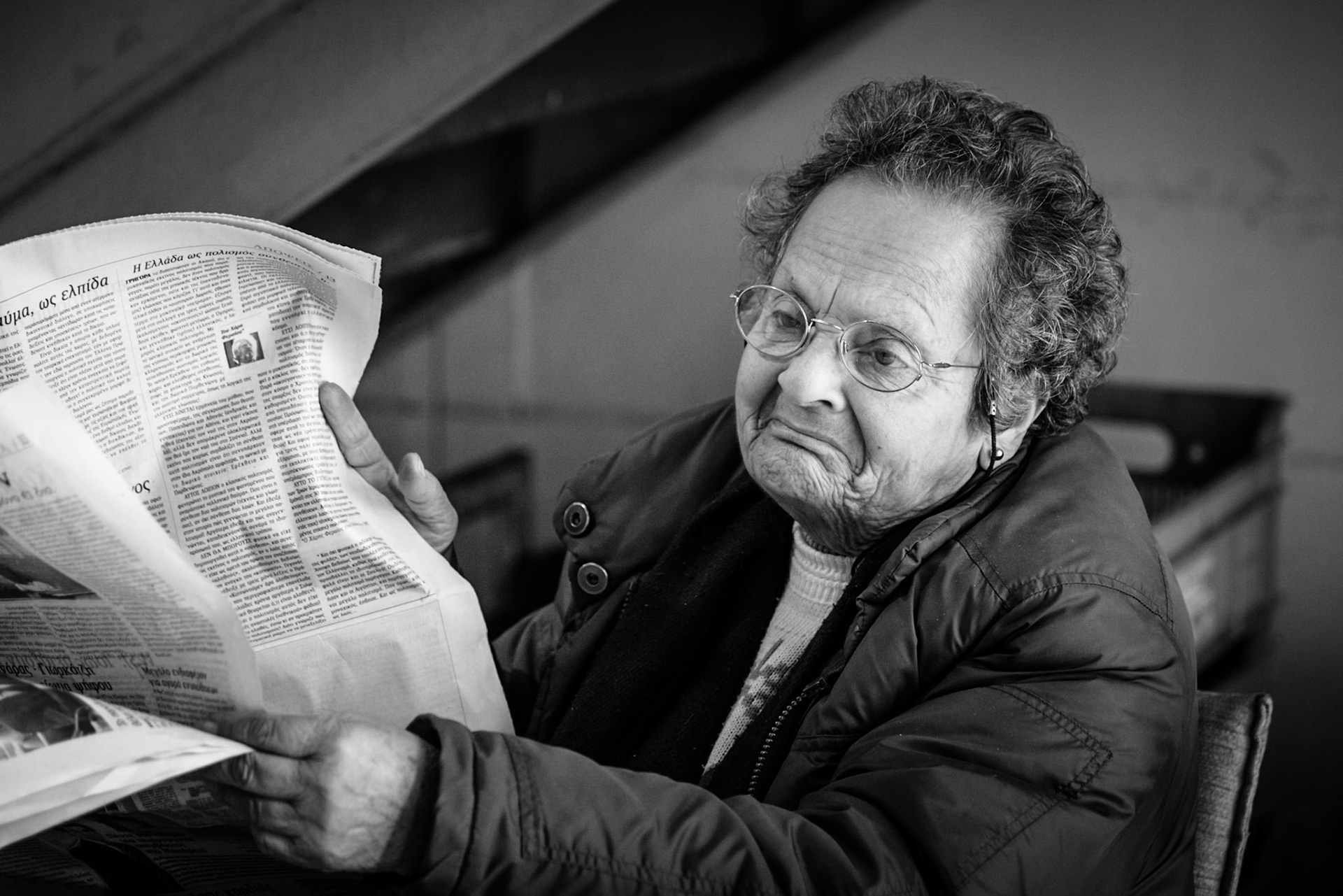 Old lady reading newspaper