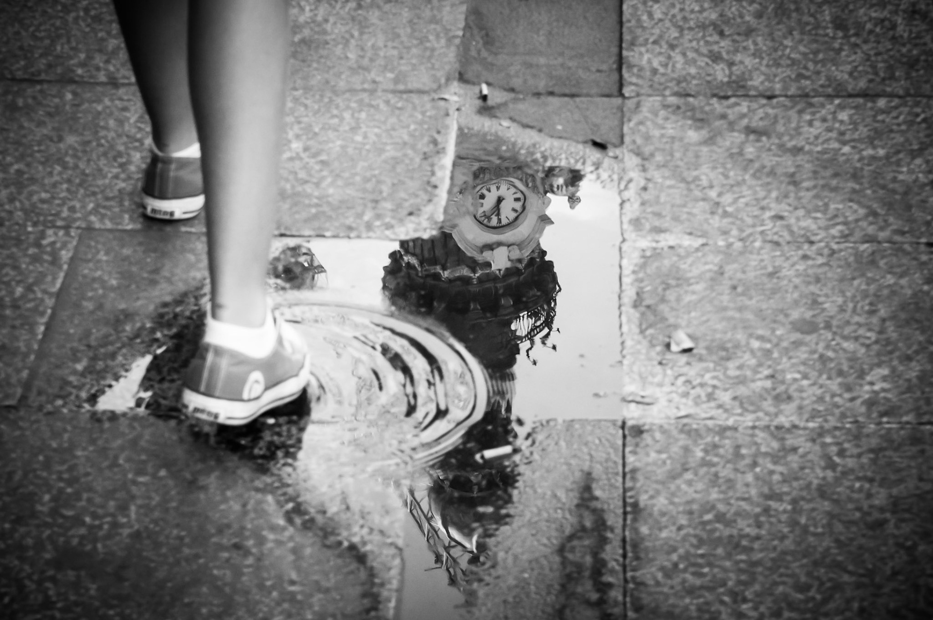 Reflection of the Banesto Building in a puddle on the pavement