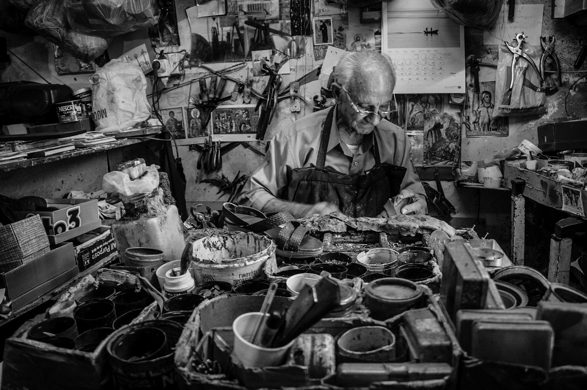 Old man repairing shoes in his store in Old Nicosia, Cyprus