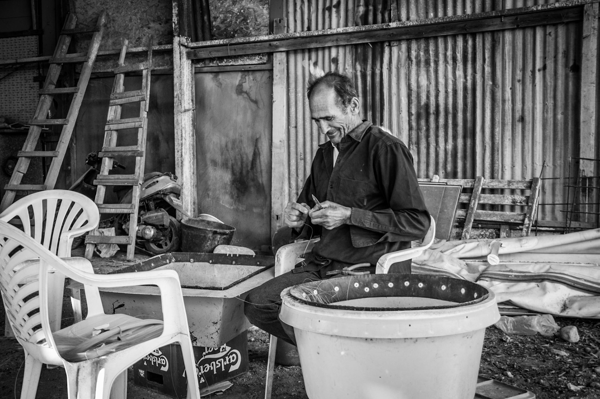 Fisherman preparing bait for a long line in Limassol, Cyprus