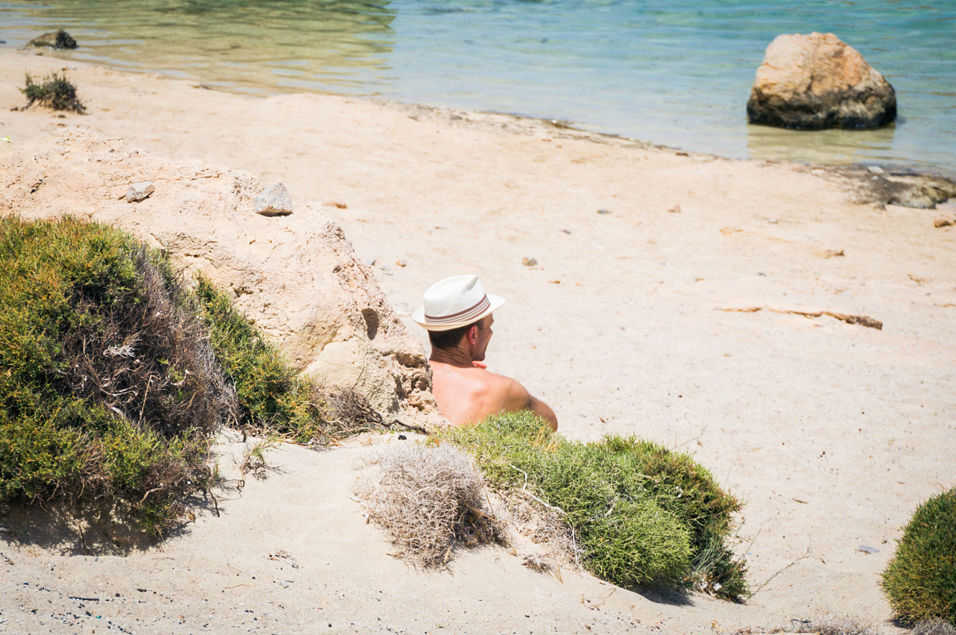 A man sunbathing at Balos beach in Chania, Crete in Greece