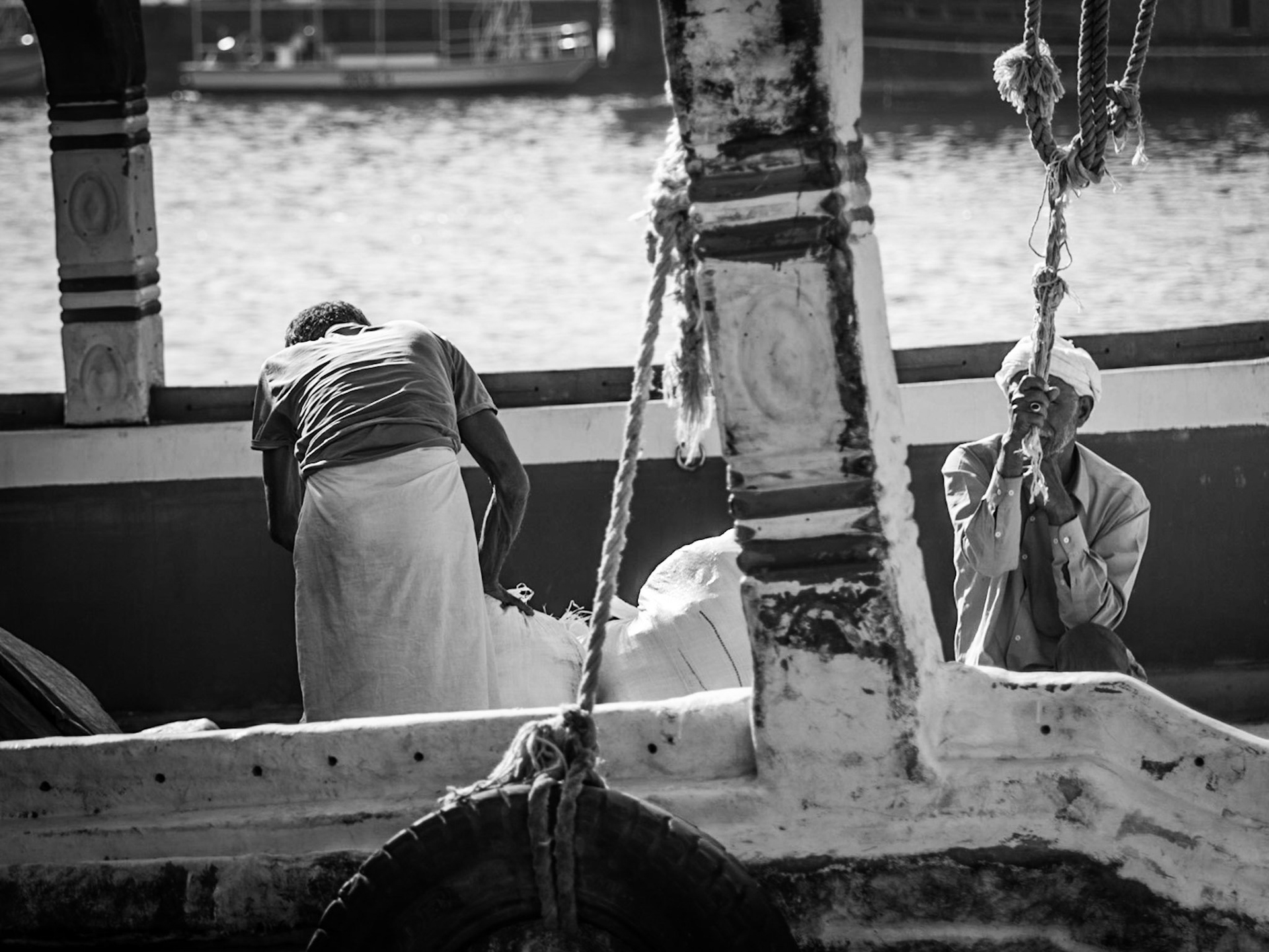 Crew members working on a dhow in Dubai Creek, UAE