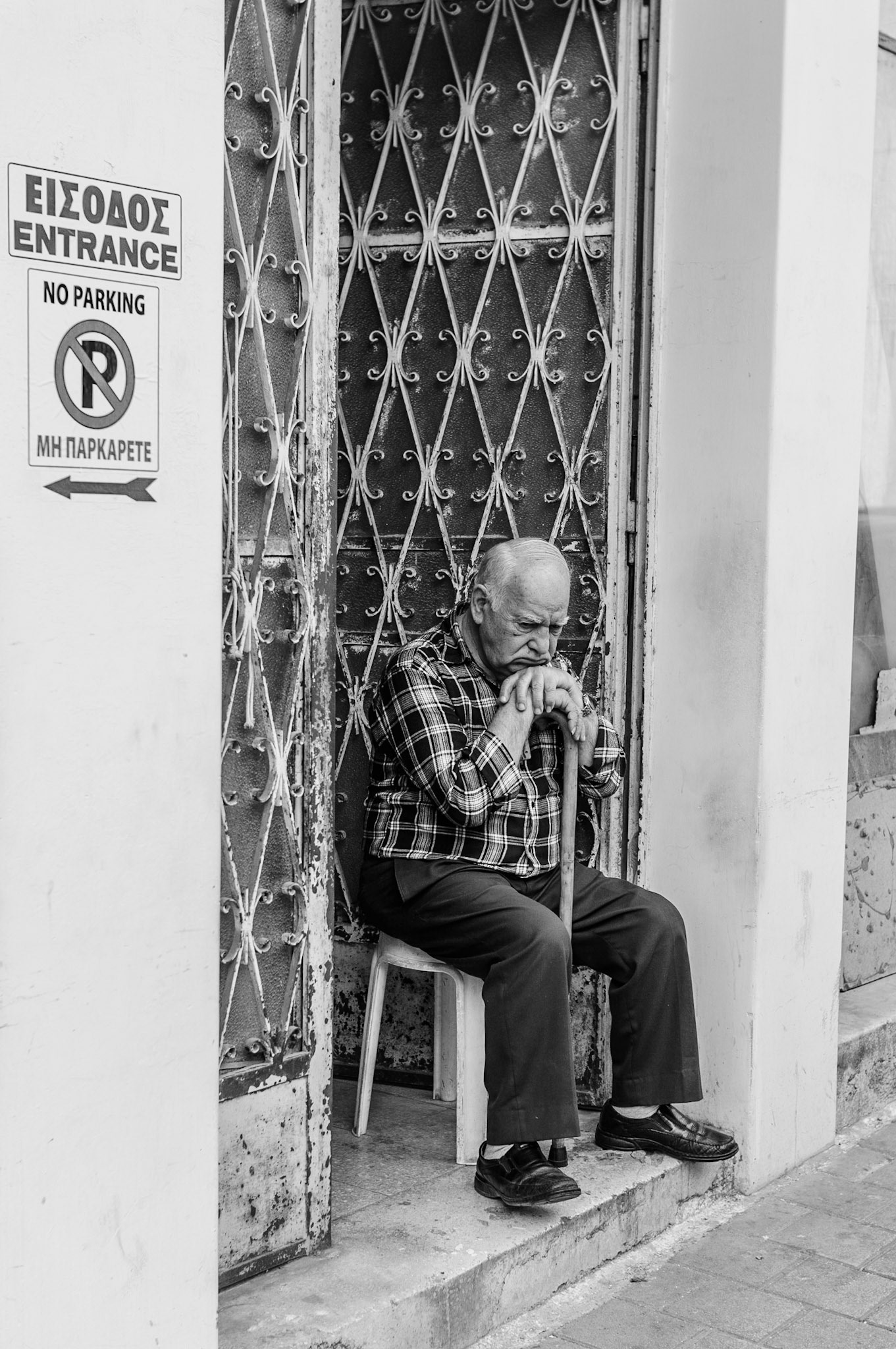 Old man day dreaming outside his house in Old Nicosia, Cyprus