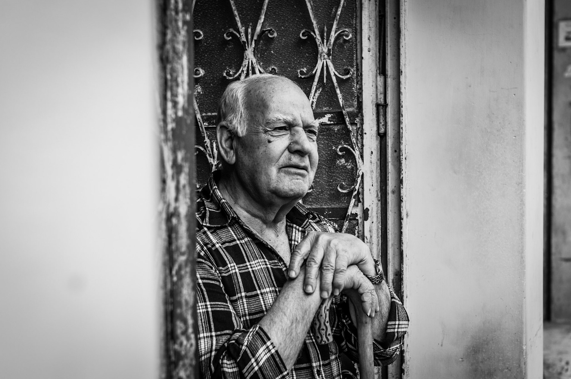 Old man day dreaming outside his house in Old Nicosia, Cyprus