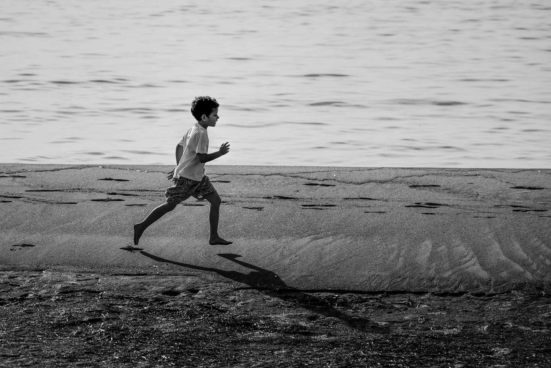 Little kid running on the beach in Limassol, Cyprus