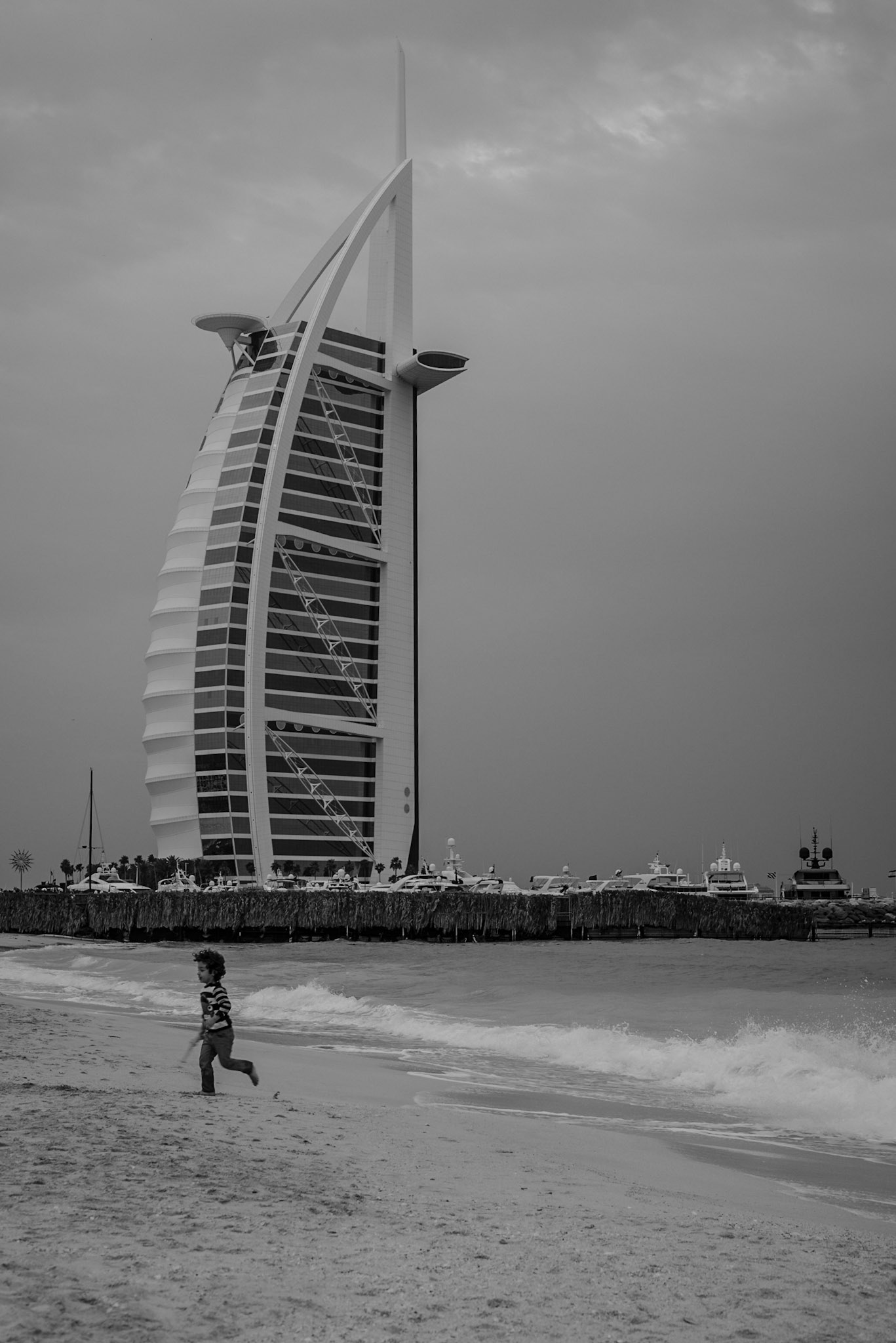 Kid running in front of Burj Al Arab in Dubai, UAE