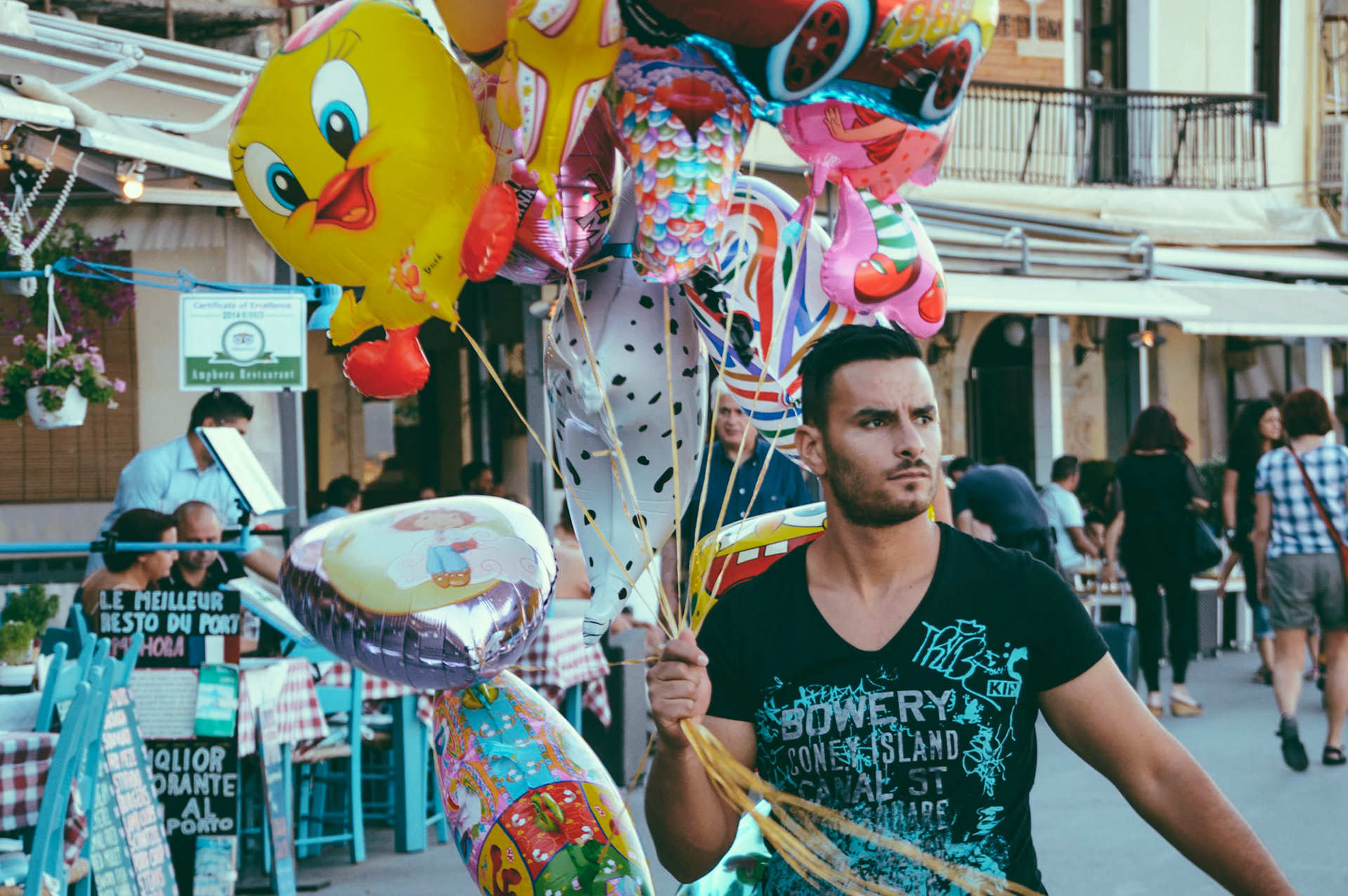 Man selling balloons at Chania Port in Crete, Greece