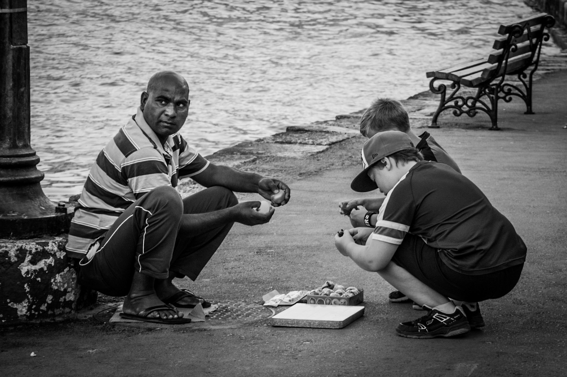 Street vendor selling toys to children at Chania Old Port in Crete, Greece