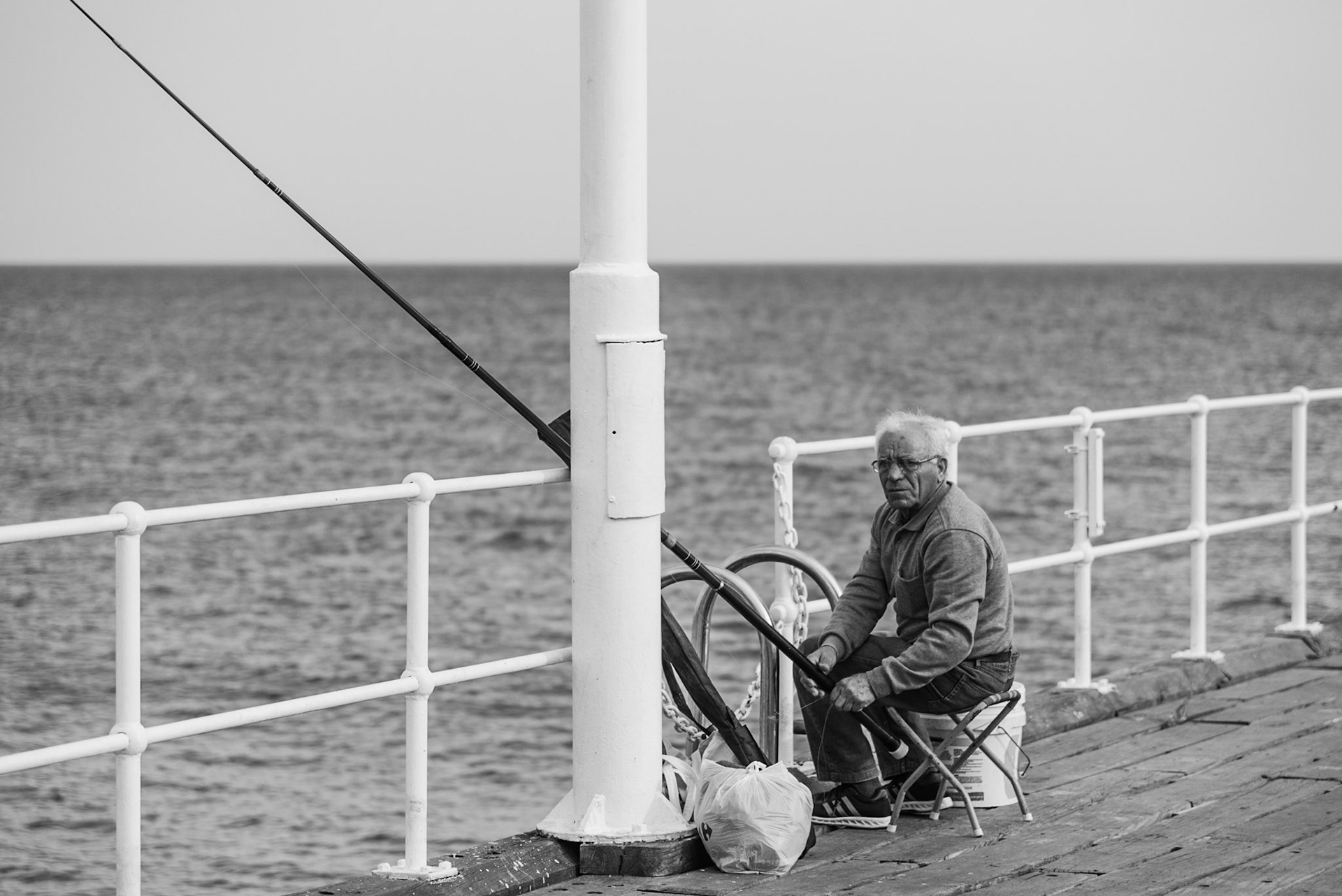 Old man fishing on Limassol's Old Pier in Cyprus