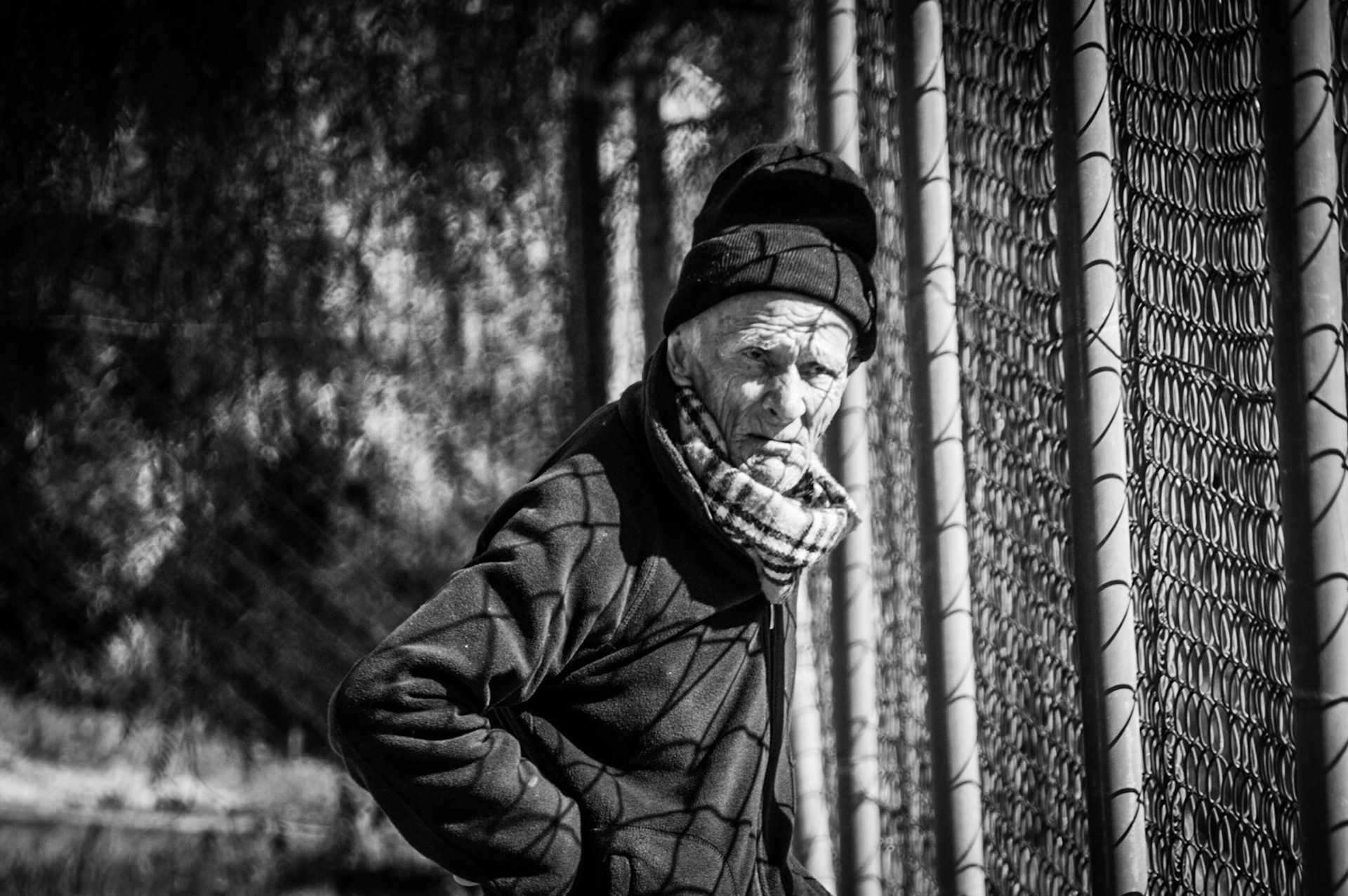 Old man in Occupied Nicosia looking over the fence