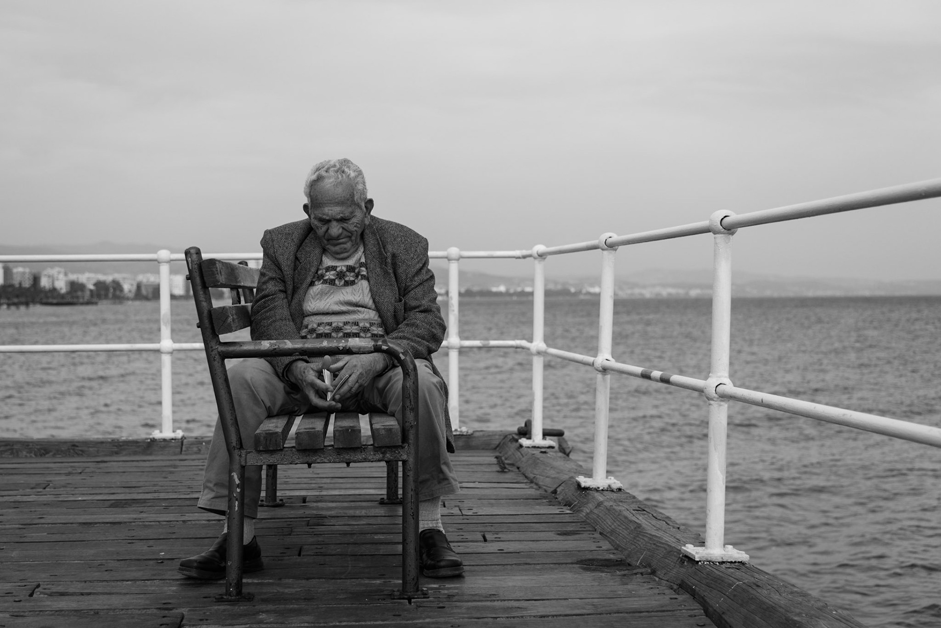 Old man lost in his thoughts on Limassol's Old Pier, Cyprus