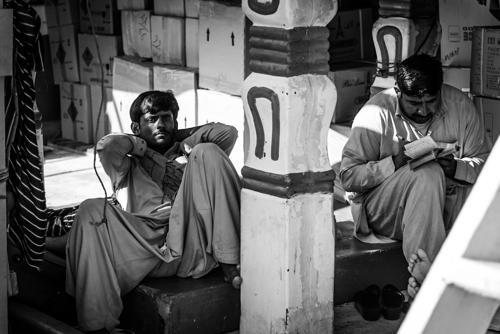 Crew members working on a dhow in Dubai Creek, UAE