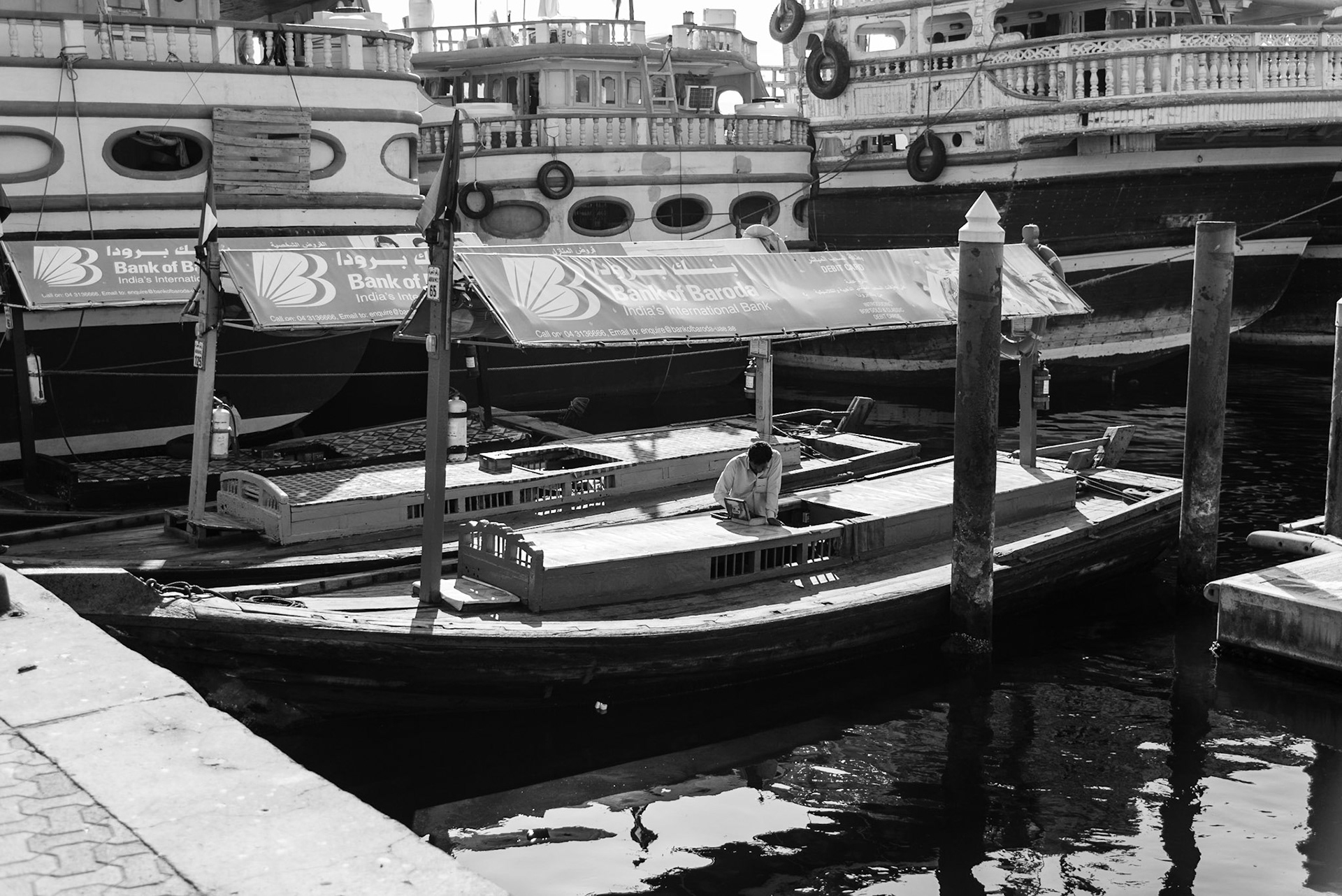 Abra driver on his boat taking his break in Dubai Creek, UAE