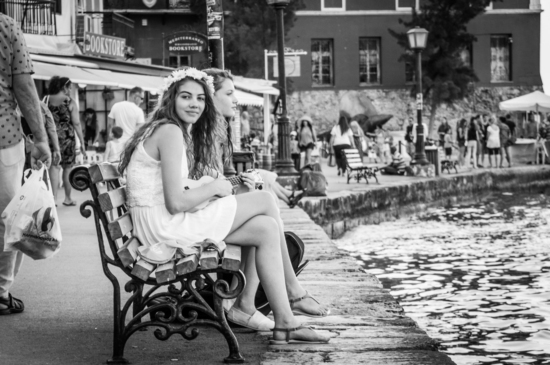 Girls playing the ukelele in Chania Port, Crete Greece