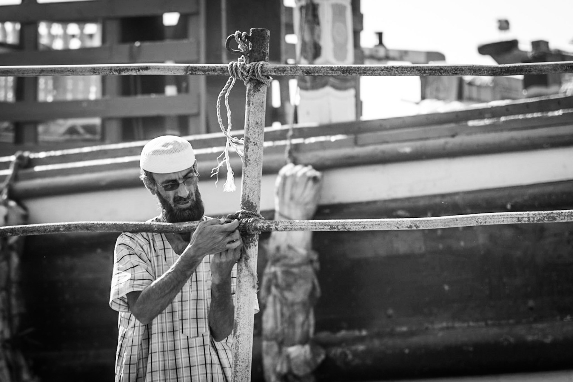 Crew members working on a dhow in Dubai Creek, UAE