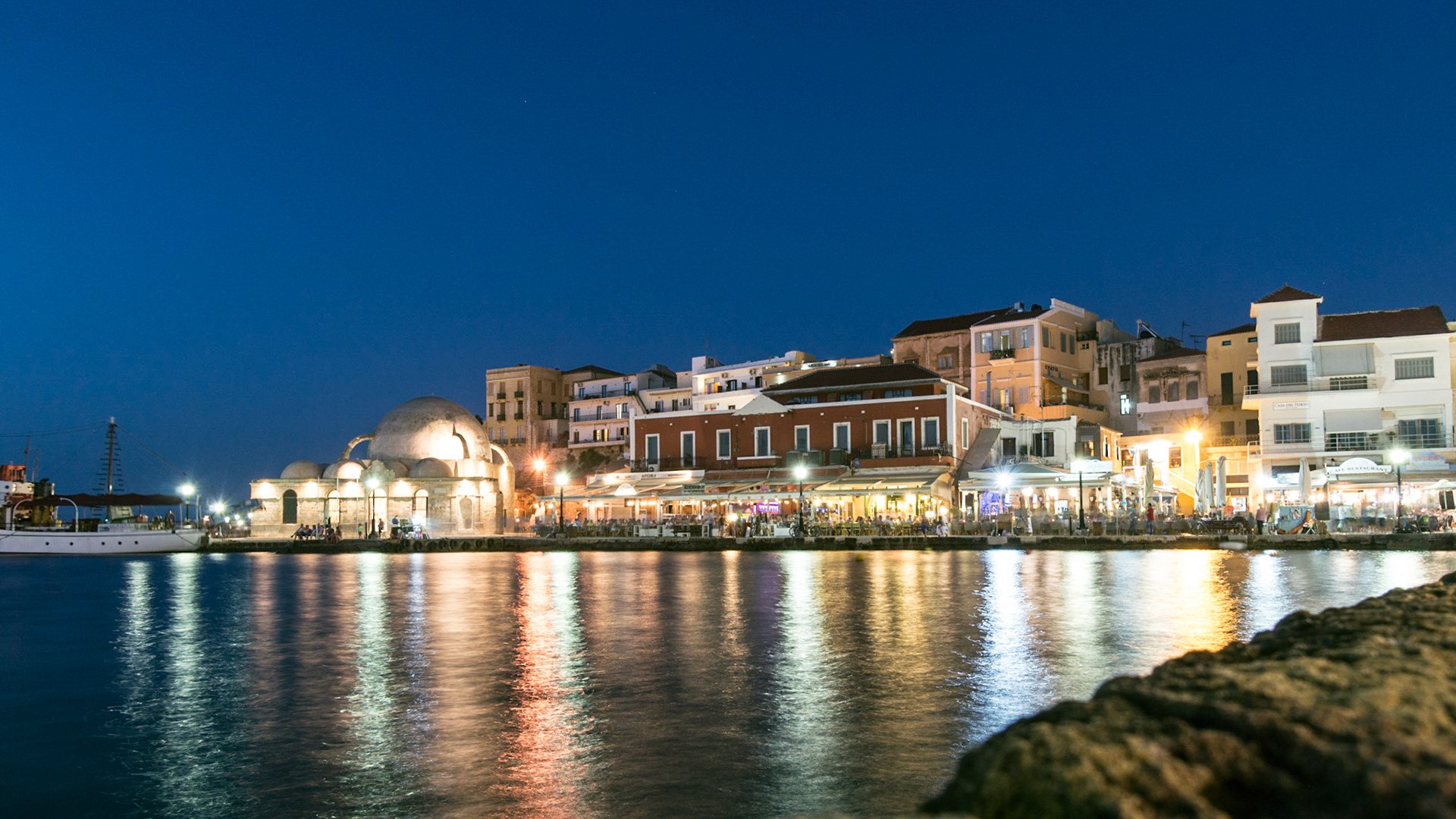A view of the busy port of Chania at night in Crete, Greece