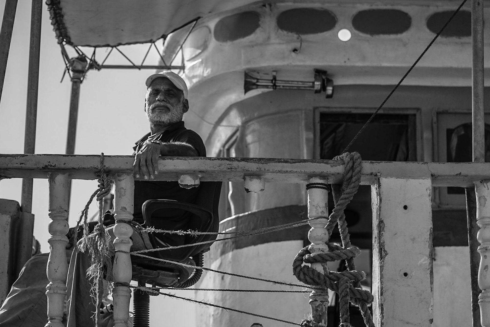 Old man resting on a dhow in Dubai Creek, UAE