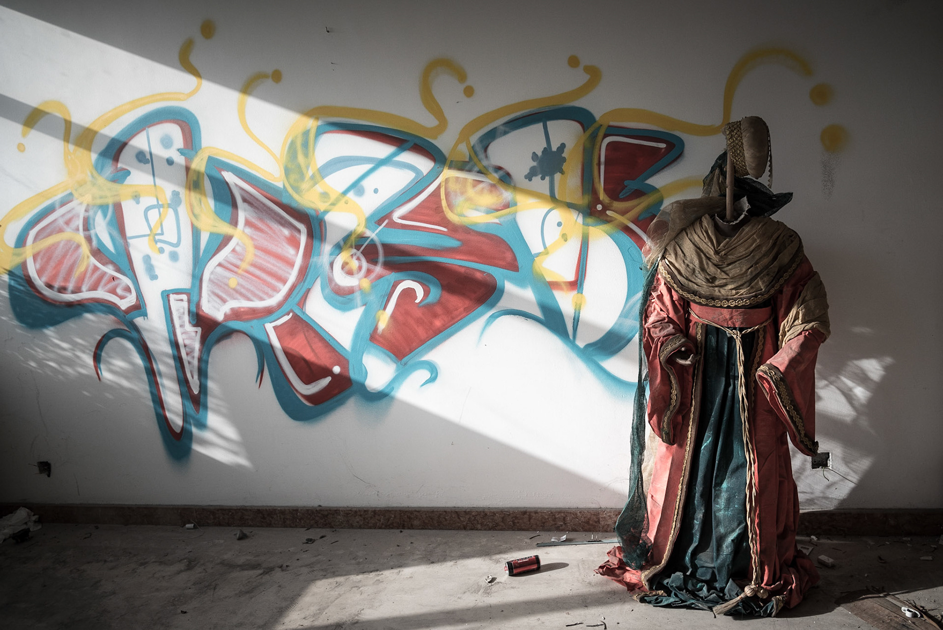 Street art on a wall behind a mannequin in an abandoned hotel in Nicosia, Cyprus