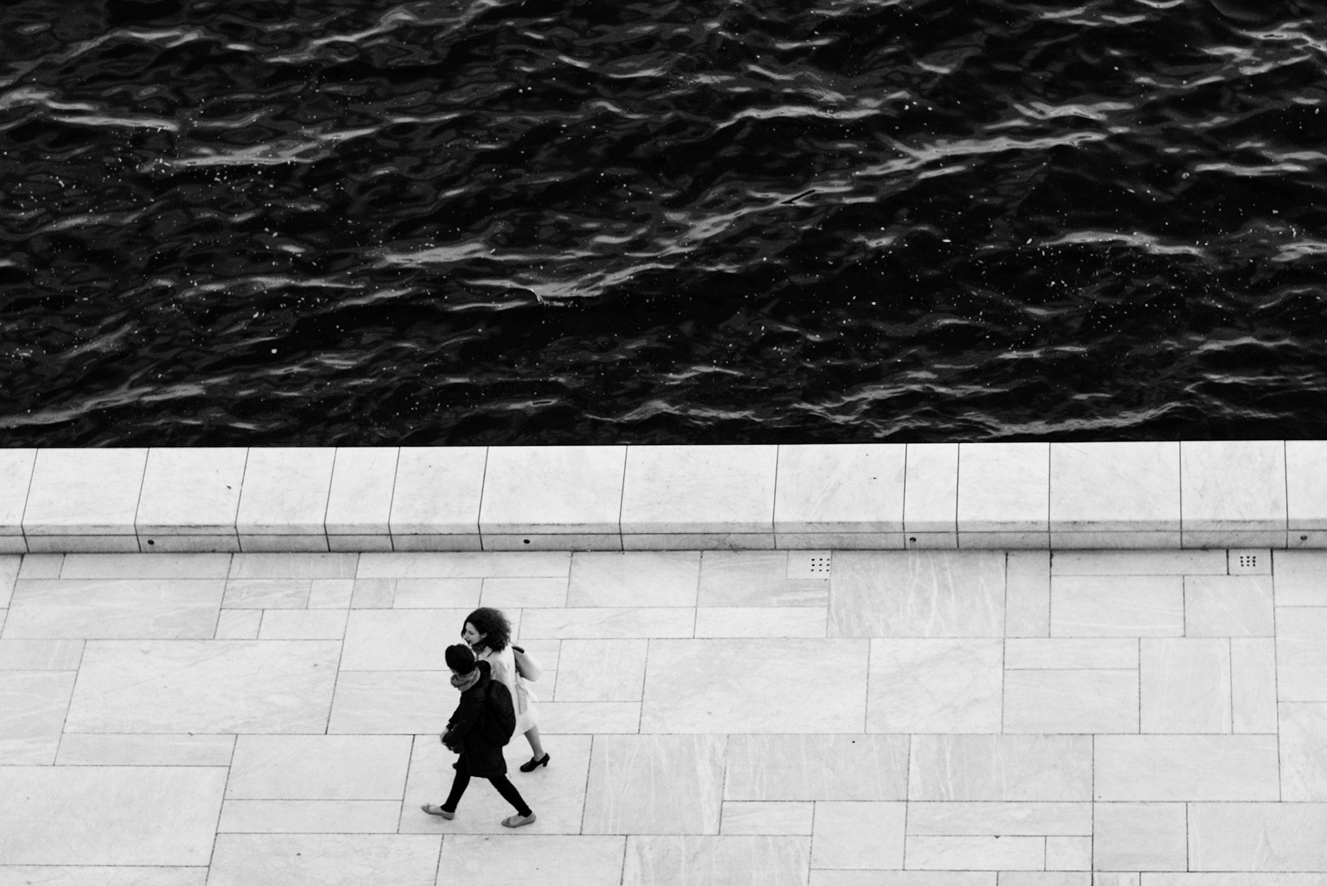 People walking at the Oslo Opera House, as seen from the roof