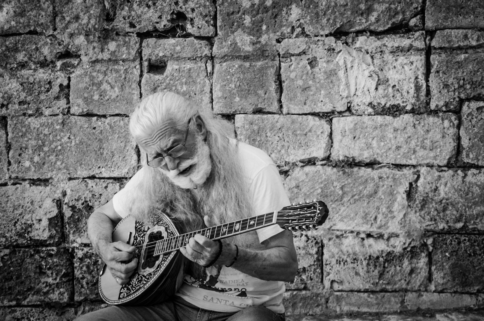 Man playing the mandolin at Chania Port in Crete, Greece
