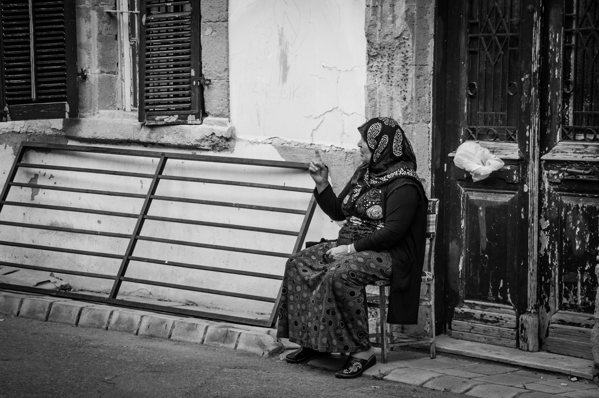 Old lady sitting outside her door in Old Nicosia, Cyprus
