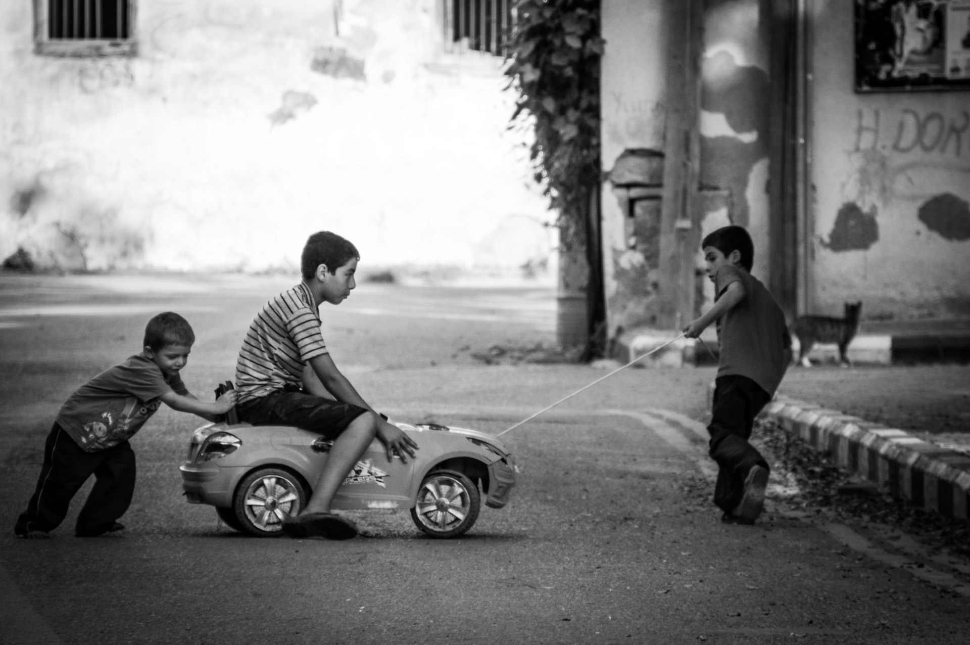 Kids playing with a toy car in Old Nicosia, Cyprus