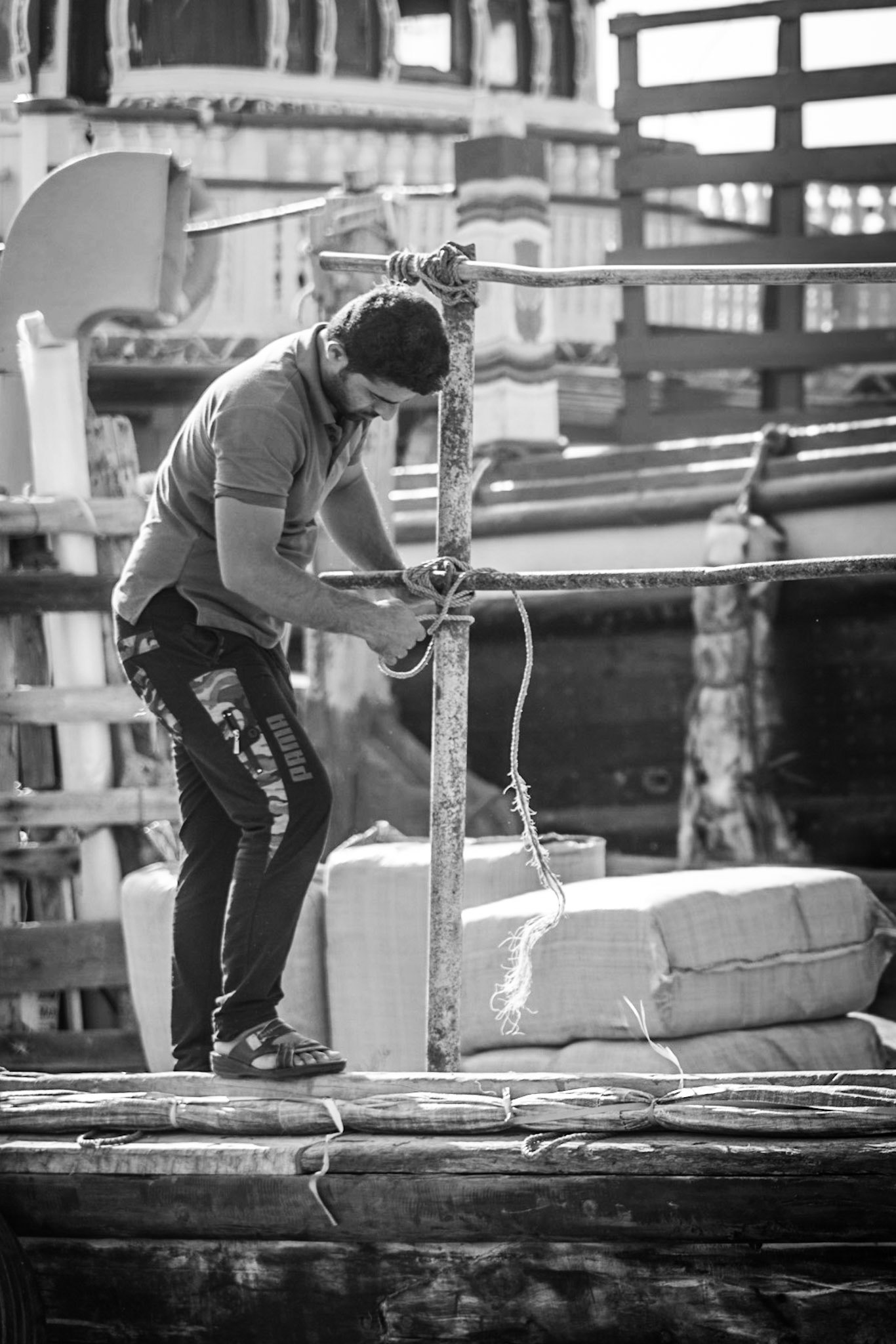 Crew members working on a dhow in Dubai Creek, UAE