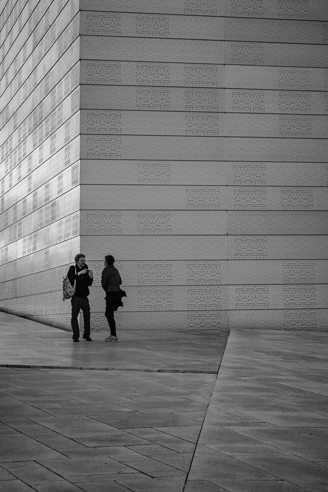 A couple taking photos on top of the Oslo Opera House in Oslo, Norway