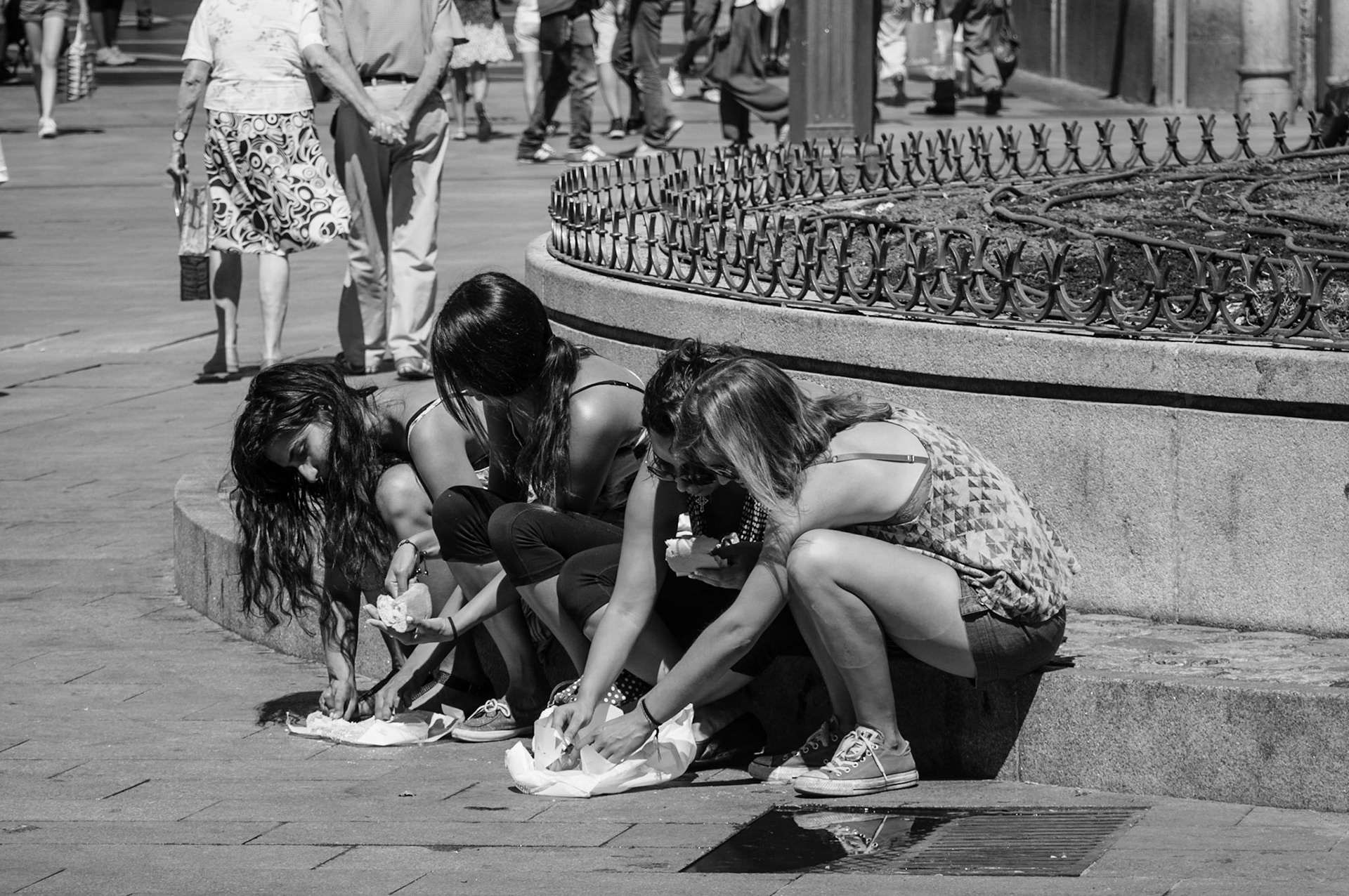 Spanish girls having their "meat" lunch at Puerta Del Sol in Madrid, Spain