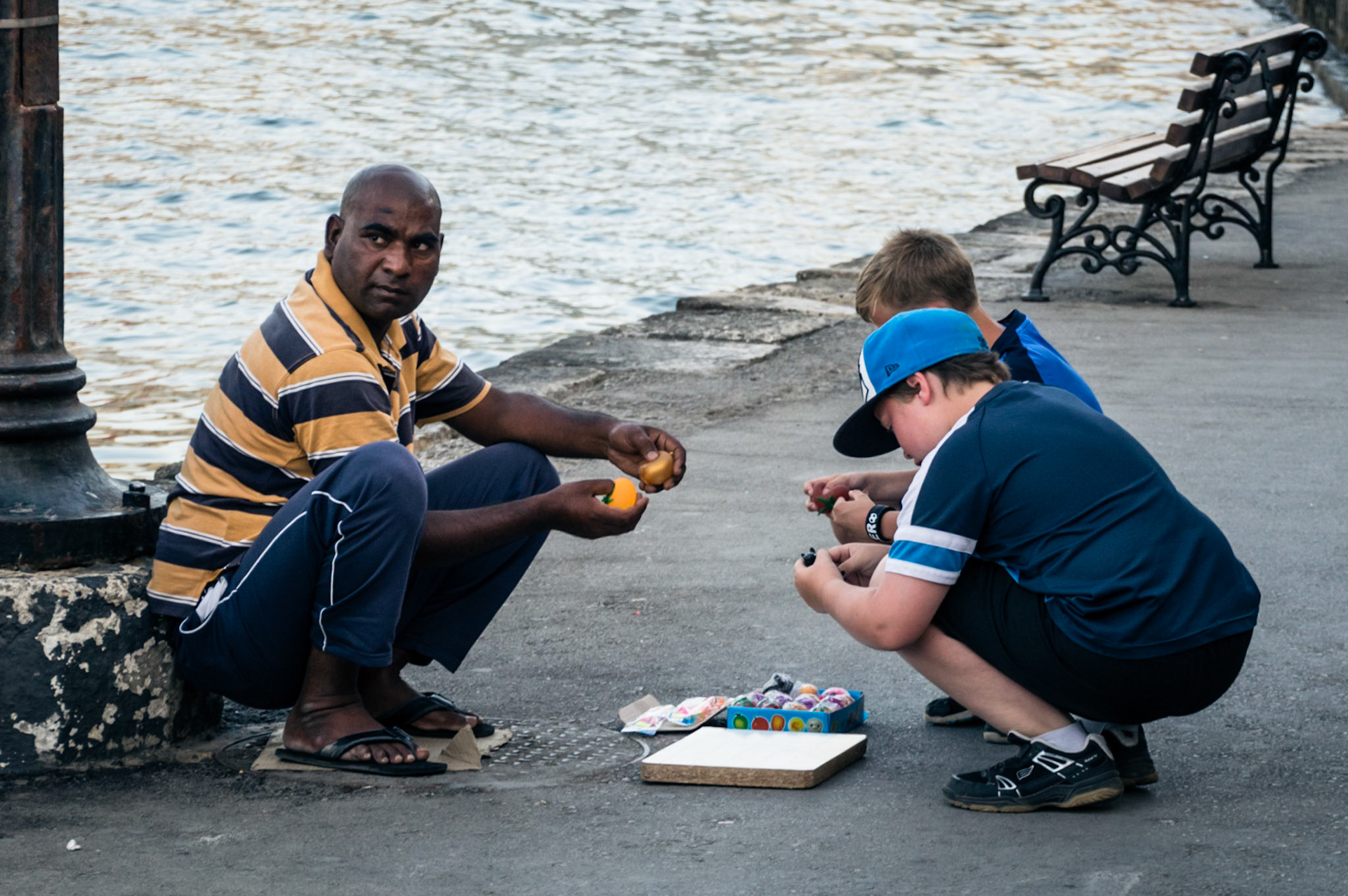 Street vendor selling toys to children at Chania Old Port in Crete, Greece