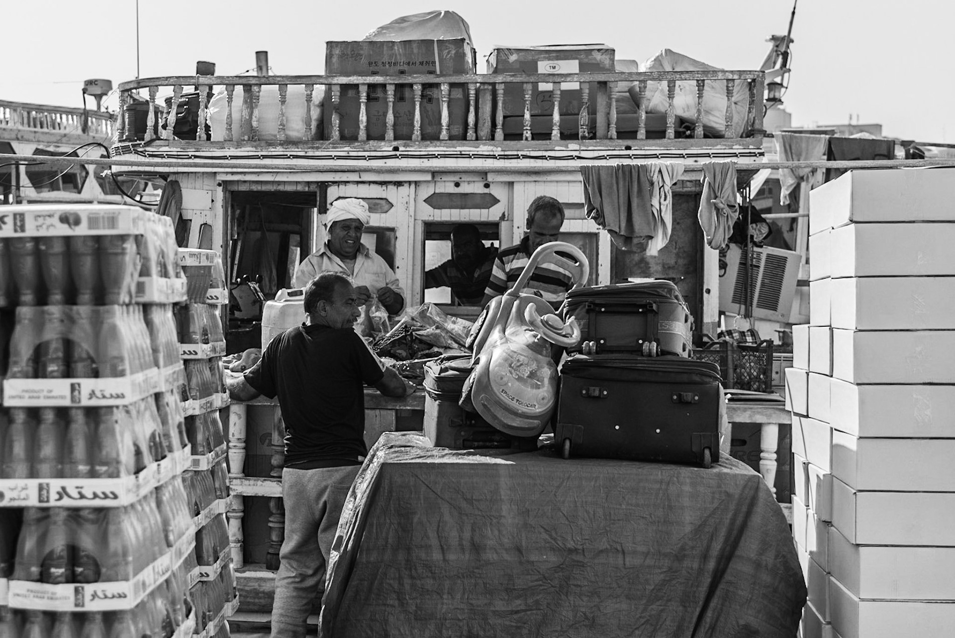 Crew members working on a dhow in Dubai Creek, UAE