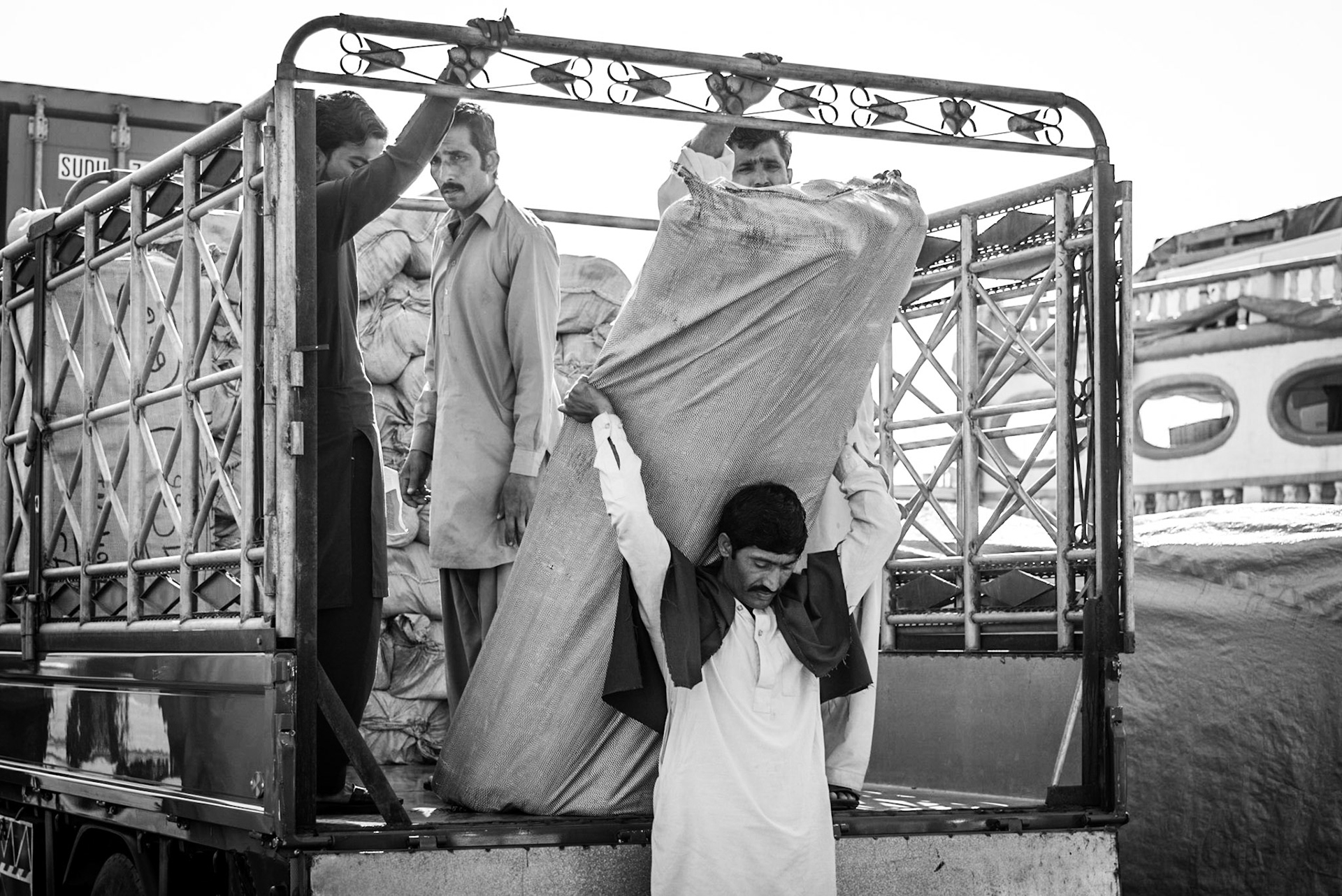 Crew members unloading a truck in Dubai Creek, UAE