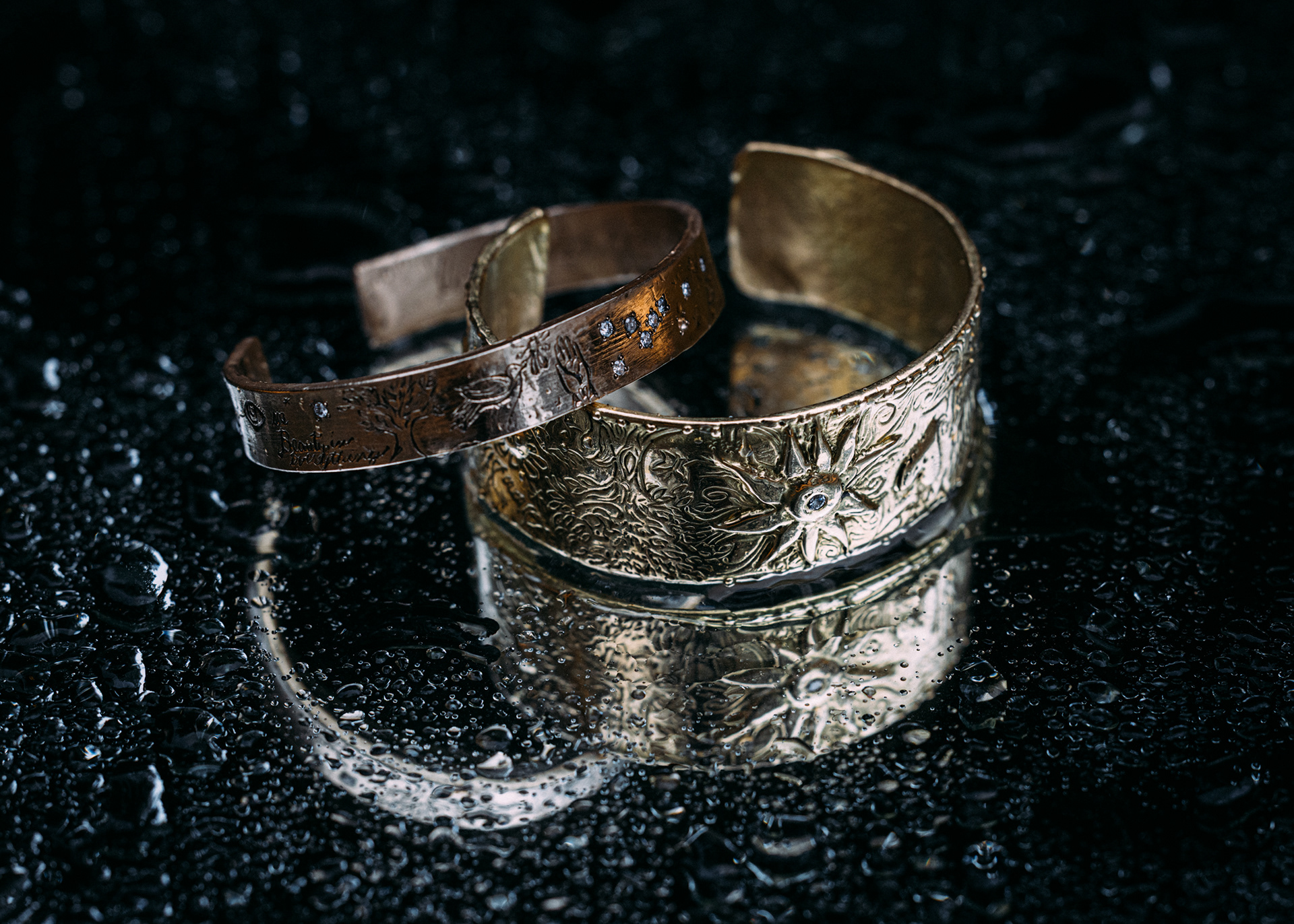 Close‑up jewelry photography with gold rings and textured fabric