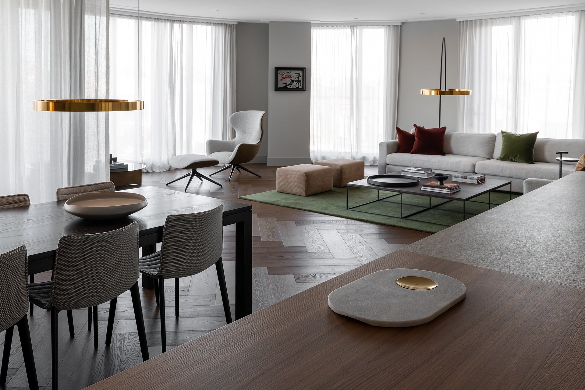 Award-winning contemporary residential interior design with open-plan living and dining spaces, sheer curtains and brass pendant lighting