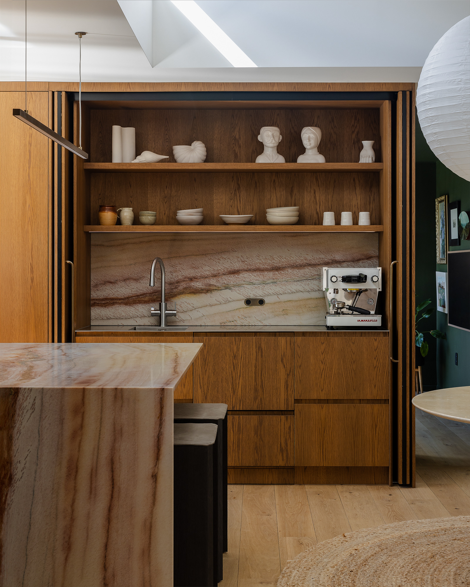 Detail of Annika Rowson’s kitchen design with timber cabinetry, quartzite splashback, open shelving and integrated coffee station