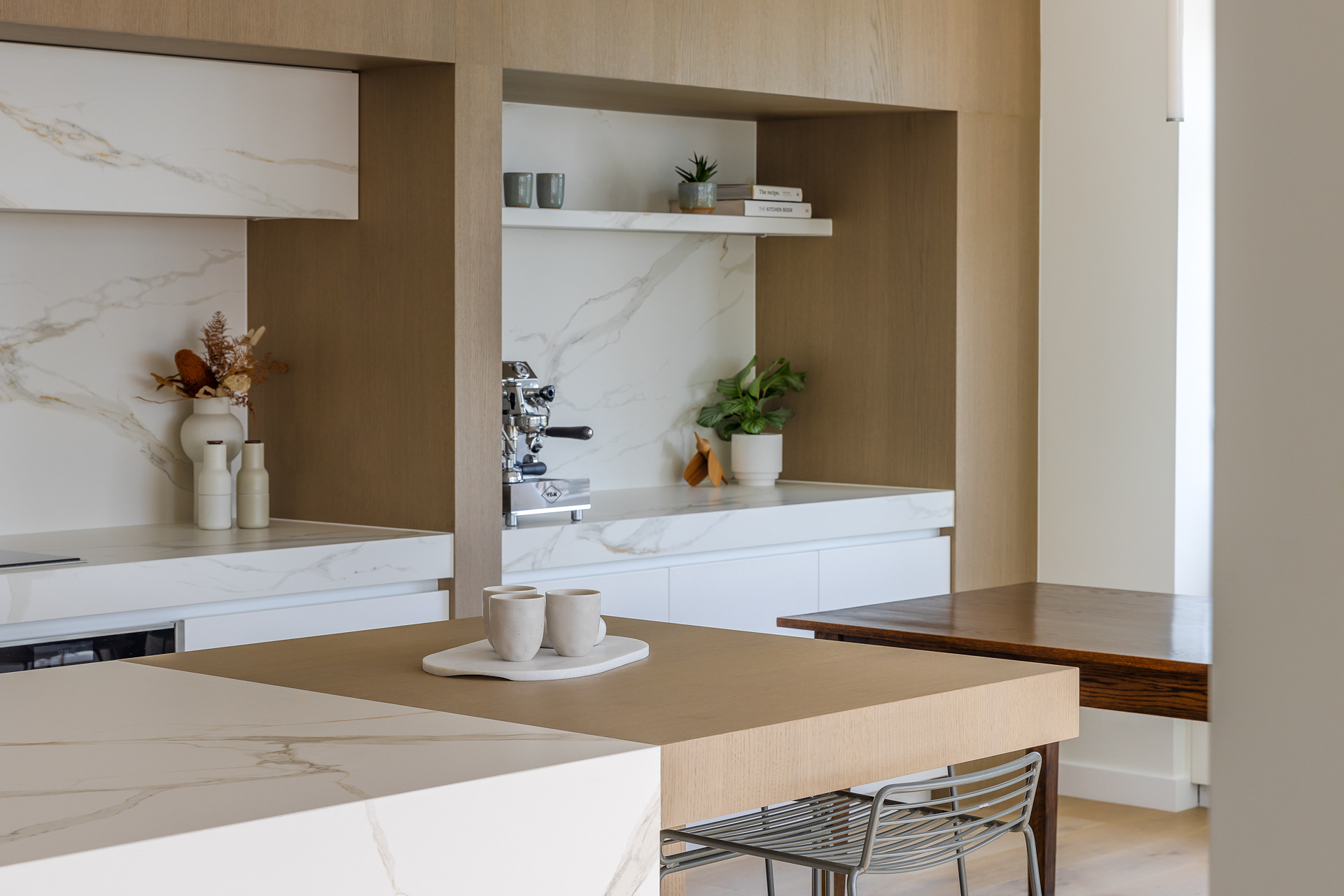 Codrington Residence kitchen detail with timber cabinetry, marble-look surfaces and integrated coffee station