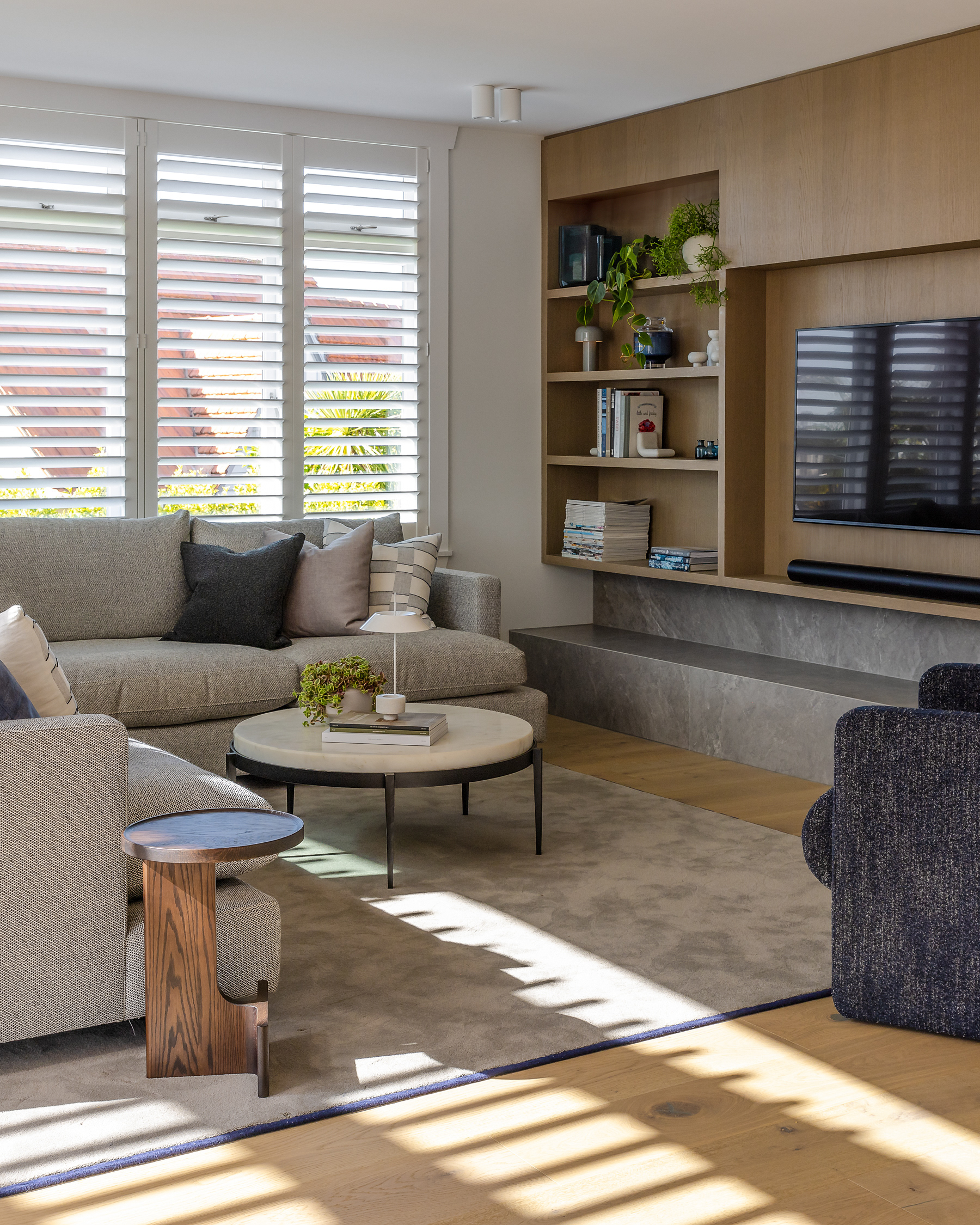 Codrington Residence living room with natural light filtering through plantation shutters across contemporary furnishings