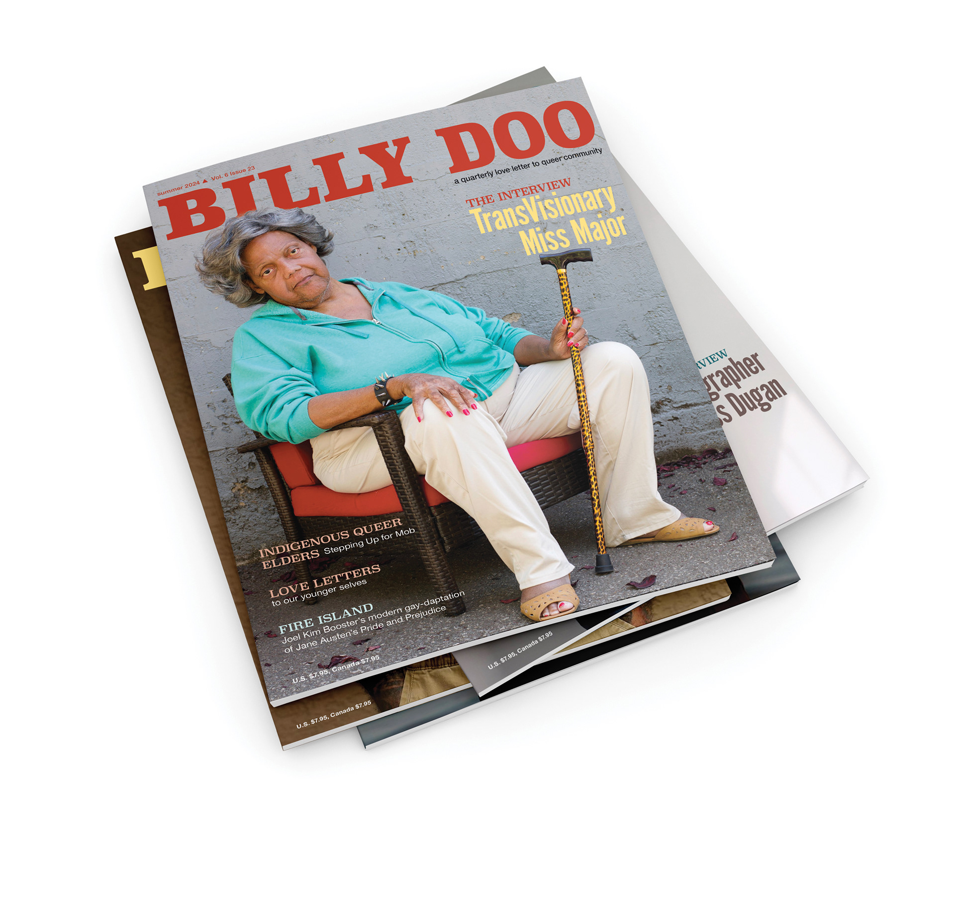 A stack of magazines. The top cover shows a photo of a powerful Black, trans elder. She is sitting in a chair holding a leopard print cane in one handd and wears a leather spiked bracelet. She looks right into the camera.