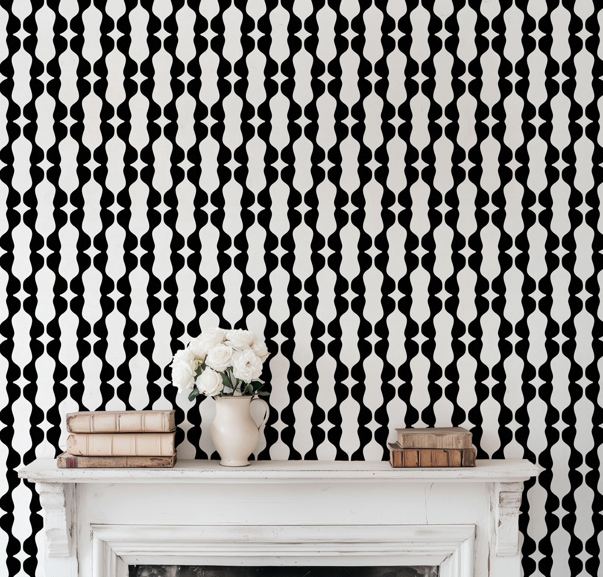 Black and white contemporary wallpaper with vertical wavy stripes displayed above a white fireplace mantel decorated with vintage books and a cream vase holding white roses.