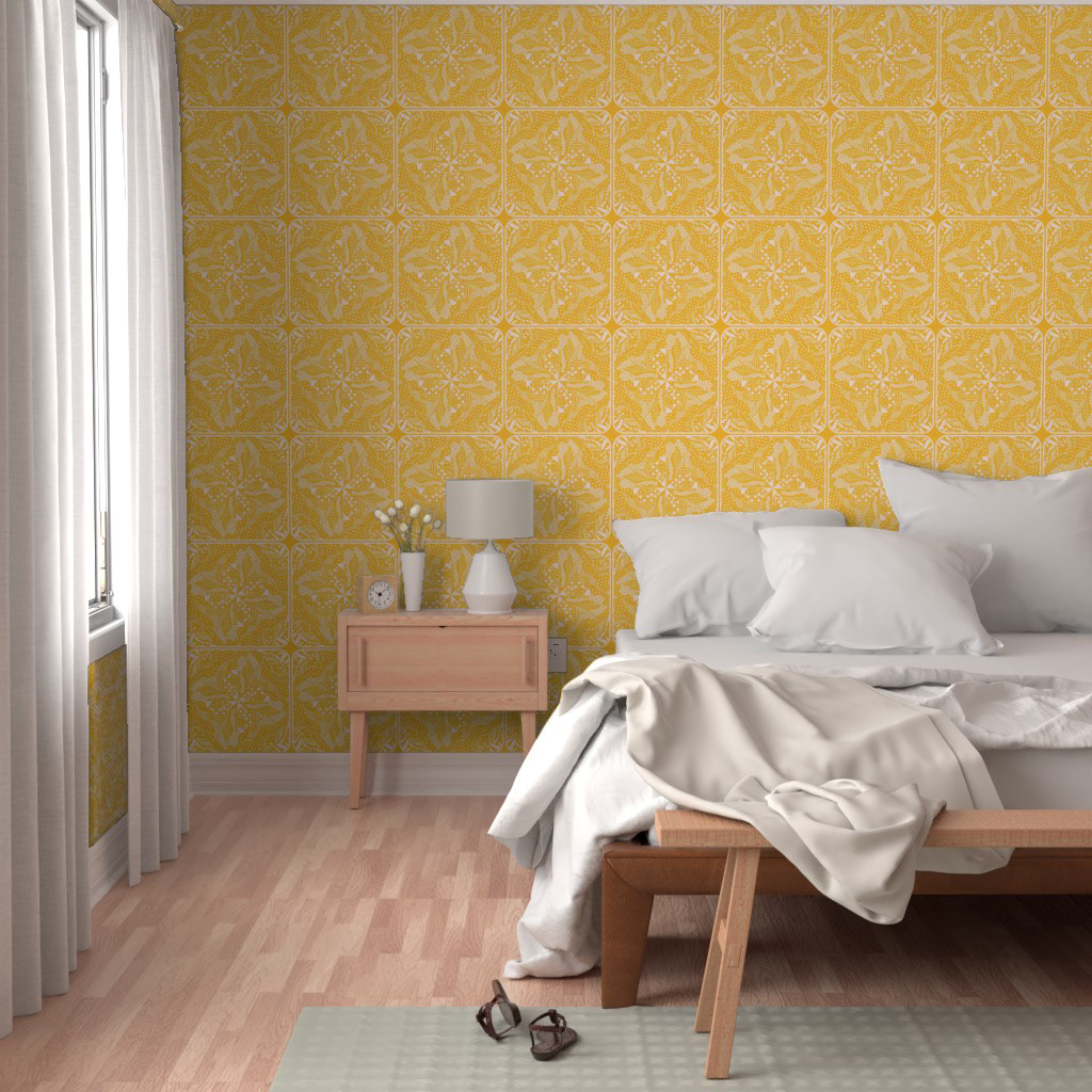 Bedroom with mid-century modern style featuring mustard yellow wallpaper in a geometric tile pattern. The room has light wood flooring, white bedding, a simple wooden bench, a matching wooden nightstand with a white lamp and vase, and cream curtains.