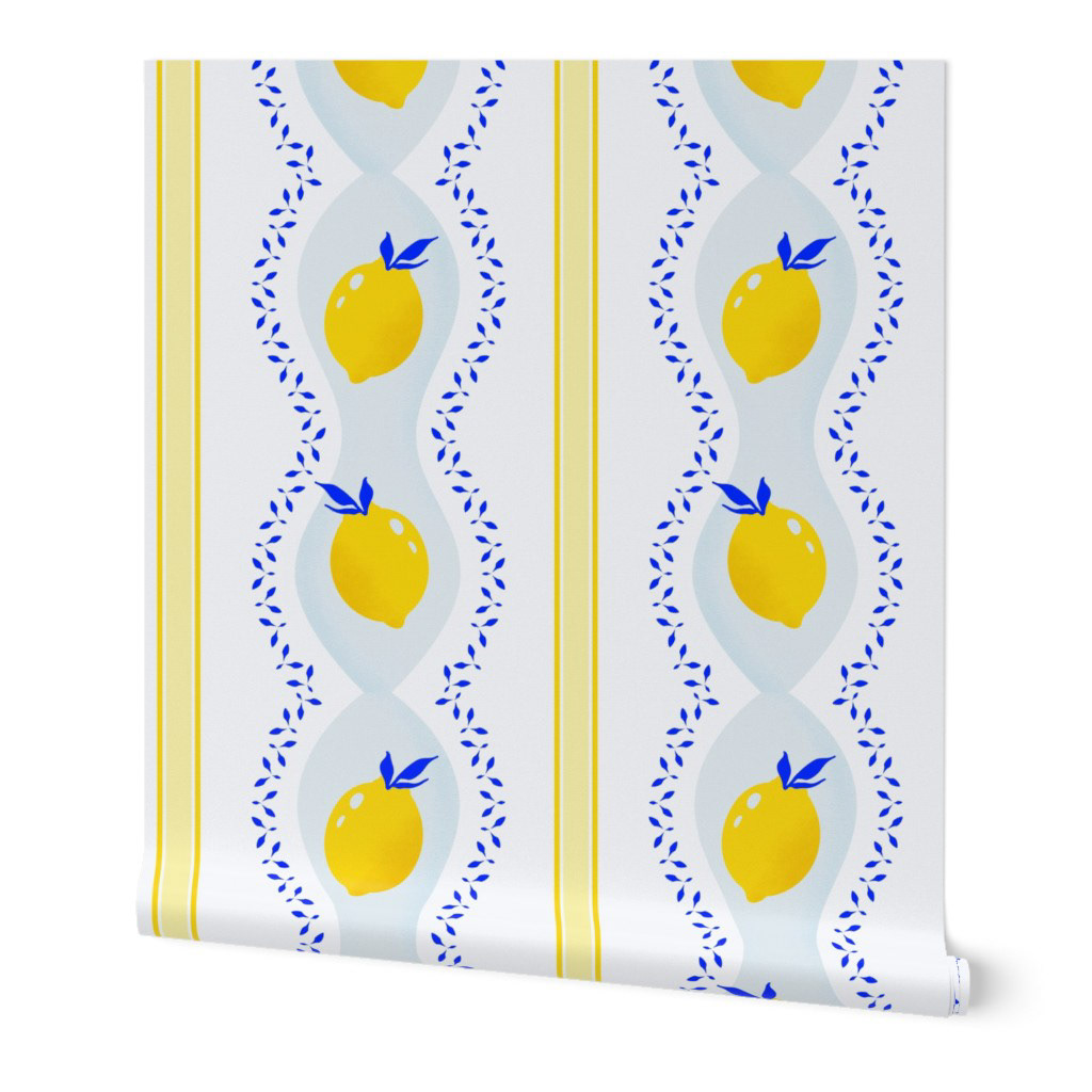 Wallpaper featuring a repeating pattern of bright yellow lemons with blue leaf accents arranged in vertical stripes on a white background, suitable for kitchen or dining room walls.