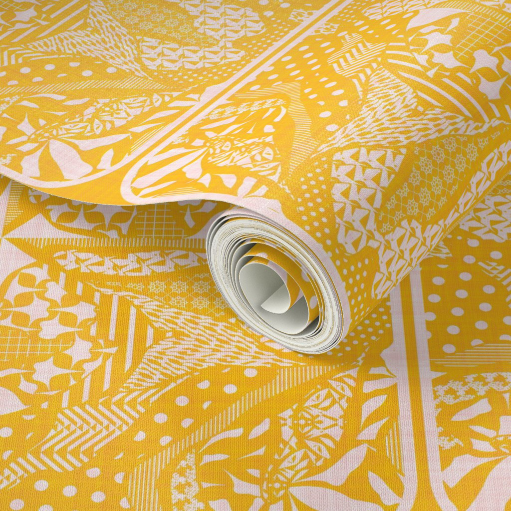 Roll of bright yellow wallpaper with a mix of geometric and abstract floral patterns in white, shown in close-up to highlight texture and intricate design details.  Designer Advice: