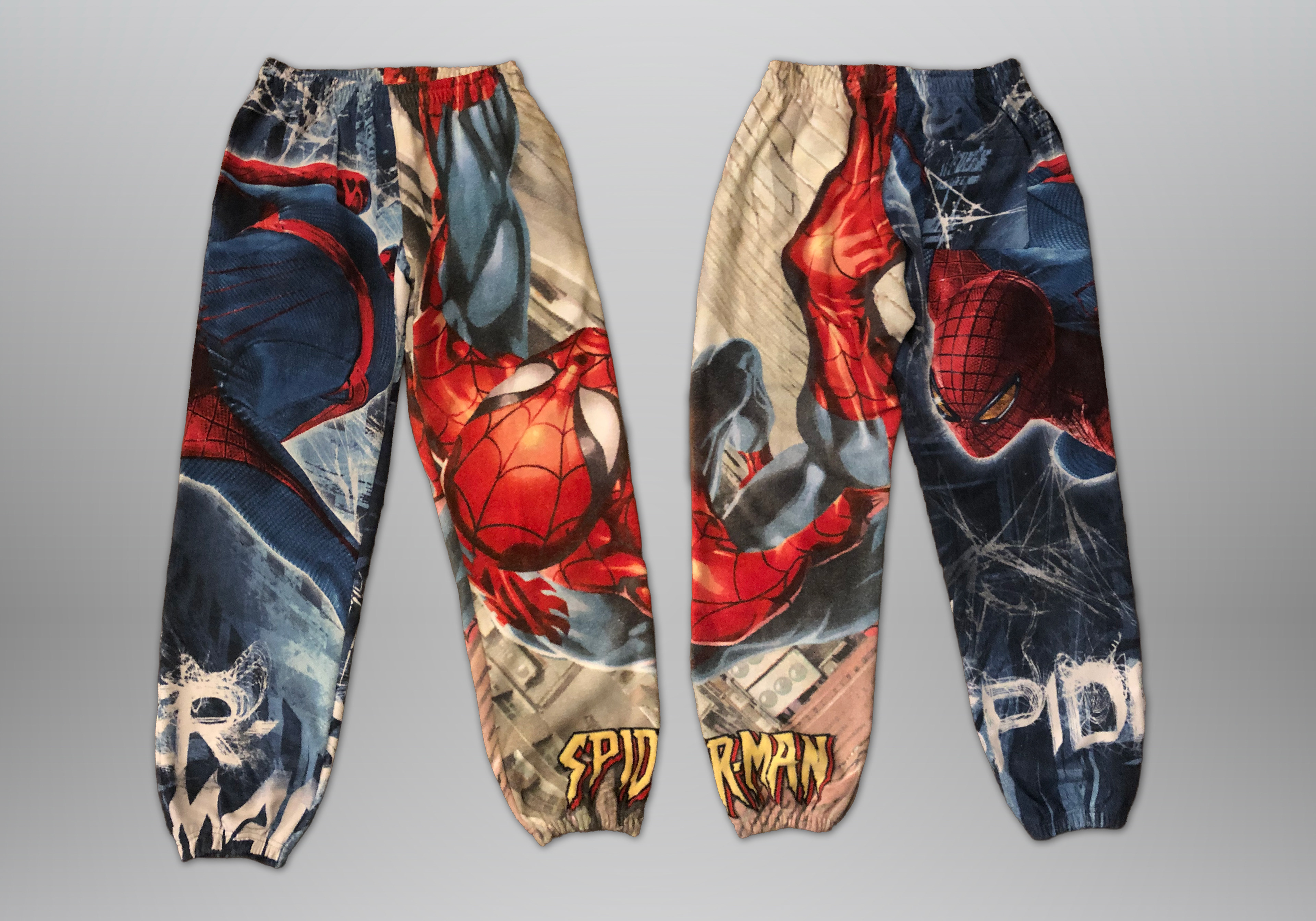 Sewn from Spiderman beach towels. Features elastic waistband, drawstring, 2 deep side hem pockets, and one back pocket.